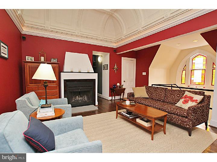 A gorgeous, distinctive condo unit which features a perfect blend of historic architecture and details with sleek, modern style and comfort. One of 5 units in a renovated corner brownstone home, enter and discover charming stairwell with high ceilings and large, beautiful stained glass windows-leading you into the open living room, which immediately catches your attention with its wood burning fireplace, vaulted 15' ceilings, domed moulding, all of which showcases the gorgeous, intricate stained glass skylight. Hardwood flooring and surround sound wiring throughout, the living room naturally flows into the kitchen, complete with concrete counters and backsplash, KitchenAid stainless steel appliances, custom espresso cabinets and an oversized island which houses Miele washer and dryer. Continue through to the hallway, which leads you to the two light filled bedrooms with custom closet space, and two elegant bathrooms, both featuring tubs and showers with tile to the ceiling. This unit also includes a fabulous private deck with breathtaking views of the city skyline. Located in the heart of Rittenhouse Square, this condo is blocks away from a variety of highly acclaimed restaurants, fantastic shopping and world renowned entertainment venues.