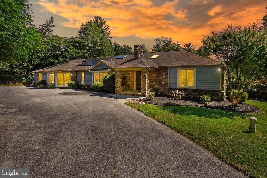 Welcome to 12325 Falls Rd! This immaculate 4-bedroom, 4.5-bathroom home in Cockeysville sits on nearly 2 acres and is filled with updates and thoughtful details throughout. Energy efficiency meets elegance with owned solar panels that cover up to 80–90% of utility costs, and fresh paint, new carpet, and ample natural light make this home truly move-in ready.

The main entry greets you with stunning marble floors and a double-sided fireplace, opening to a spacious living room with hardwood flooring and beautiful detailed molding. The kitchen features stainless steel appliances, an island with breakfast bar, skylights, and a bright dining area, while the formal dining room is accented with classic molding. A generous family room with hardwood floors and a guest half bath complete the main living spaces.

The main level offers 4 bedrooms, including a spacious primary suite with a sun-filled sitting area, large walk-in closet, and luxurious private bath with dual sinks, soaking tub, and separate shower. Two additional full bathrooms serve the remaining bedrooms, along with the convenience of a main-level laundry room.

The lower level provides even more living space with a large recreation room with new carpet, a full bathroom, and generous storage and utility areas. Outside, enjoy a freshly landscaped yard, expansive rear deck, and plenty of room to entertain.

With skylights, natural light, elegant finishes, and energy savings, this home is the perfect combination of comfort, efficiency, and style. Schedule your private showing today!