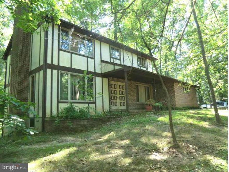 This Colonial sits on a 'Nature's lovers' hill w/mature trees*Driveway & 2 car Garage*4Beddrooms*2.5 baths*Updated Kitchen/Family Rm. w/screened in Porch*Expansive Living room w/FP* Master Bedroom Suite w/FP & Master Bath w/whirlpool tub/separate shower*Open deck off of the Living Rm & Family Rm* Full unfinished walk-out basement.*A lot of house for a great price!!!