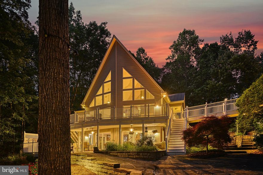 Check out this amazing Contemporary Style Waterfront Home with impressive hardscape and landscaping! Located in premier Magnolia Harbour neighborhood, this 5 bdrm (3 bdrm septic) home is loaded with upgrades from the 24 ft. pitched window wall featuring lake views, solid American cherry hardwood flooring on main and upper levels, engineered hardwood flooring on the lower level and solid core room entry doors. The main floor includes a 22 ft. long primary suite with private balcony, custom walk-in closet and ensuite with large 2-head shower and granite counter with double vanity!  The large gourmet kitchen boasts quartzite countertops and cabinetry on all four sides and an island featuring a prep sink, not to mention kitchen aid appliances including double wall ovens and under counter drawer microwave. On the lower level you will enjoy a large Rec Room with Custom Bar, large Laundry Room, a hobby room, two full bedrooms and a full bathroom with double vanity. On the upper level you will discover two more bedrooms, another full bathroom with double vanity and a loft area with great water views! Additional features for this home include a full water treatment system, hot tub adjacent to a covered patio, hot/cold outdoor shower and 23x35 oversized detached garage with an unfinished second level. At the 227 ft. shoreline, you will find a large (1200+ sq. ft.) boat dock with two slips both including electric boat hoists, a kitchen/bar with hot and cold water and a dedicated large storage area. Back at the house, you can enjoy your morning coffee or evening drink from a multitude of outdoor choices…the main level full length sundeck, one of the lower-level covered porches, the screened porch or even the primary suite private balcony. So many more features with this property! Be sure to check out the pictures and Virtual Tour.