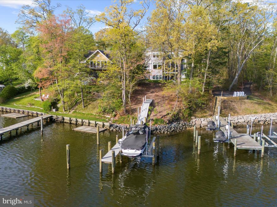 Live the waterfront lifestyle you’ve always dreamed of—situated in coveted Severna Park. Nestled on a private .81-acre lot, this stunning 6BD, 5BA home offers over 5,300 square feet of refined living space with sweeping water views and nature.
Start your mornings with coffee on the screened porch as the birds serenade you, and end your day with a sunset boat cruise launched from your private pier—complete with a boat lift, (13,000 lb) jet ski lift, and durable, low-maintenance WEARDeck boards.  At lowest tide water depth was 6ft! 
Inside, luxury abounds. Soaring 10-foot ceilings, wide-plank luxury flooring, and expansive windows create an airy, sunlit atmosphere. The chef’s kitchen features Bosch appliances, double ovens, quartz countertops, a walk-in pantry, a beverage station and a custom range hood—perfectly positioned to flow into a dining space with panoramic water views. It’s an entertainer’s dream, ready for your next gathering.
Hosting long-term guests or need space for multi-generational living? The fully finished walkout basement includes a second kitchen, laundry area, a second home office, and the 5th bedroom—ideal for an au pair or in-laws.
The spa-like primary suite is your private retreat, complete with a soaking tub, walk-in shower, and custom California closets. Guest rooms feature en suite or dual-vanity baths to ensure comfort for everyone.
Work from home? No problem! The main level has an office OR can be used a 6th bedroom.
Thoughtful upgrades include a 22kW generator, surround sound system, smart home features, 3 HVAC units, 1000 gallon propane tank for fireplace and range, remote-controlled window treatments, and upgraded insulation throughout. Every detail has been designed for comfort, function, and luxury.
This is waterfront living at its finest. Come experience it for yourself.