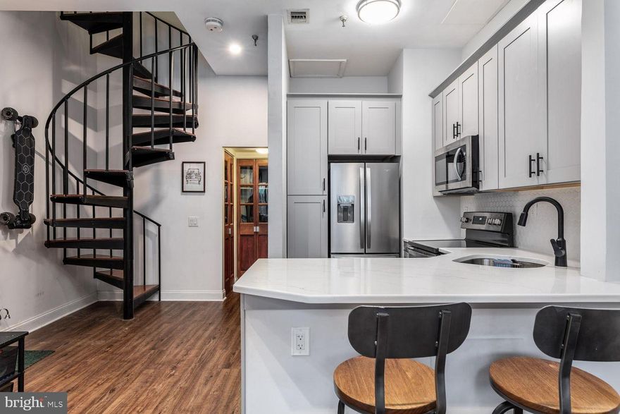 Pier 3 Condominium is located in one of America’s most historic and desirable waterfront neighborhoods. Welcome to this renovated 1-bedroom, 1.5-bath bi-level condo offering a rare combination of full-service amenities, stunning river and bridge views, and a reasonable HOA an exceptional value for Philadelphia living.

Step inside to luxury vinyl plank flooring throughout the main living level and be immediately impressed by the dramatic 18-foot ceilings with exposed beams and ductwork. Natural light floods the space through floor-to-ceiling sliding glass doors, leading to a serene atrium patio—perfect for relaxing or entertaining.

The fully renovated kitchen features quartz countertops and brand-new stainless-steel appliances, while a convenient main-level washer/dryer and half bath enhance the thoughtful layout. A spiral staircase leads to the second level, where the primary bedroom offers sun-soaked floor-to-ceiling glass doors and access to your own private outdoor deck.

This pet-friendly, private residence delivers true full-service living rarely found in Philadelphia, including:

24-hour concierge/doorman service
Gated indoor parking garage
State-of-the-art fitness center
Indoor heated pool
Lobby and common areas

All of this is included with a well-managed, reasonable HOA, making this home an outstanding value compared to similar luxury buildings in the city.

Enjoy entertaining with visitor parking passes and multiple shared spaces showcasing iconic views of the Benjamin Franklin Bridge and the Delaware River. 

The location is unmatched—steps from Old City dining, shopping, and galleries, and moments from concerts and festivals at Penn's Landing. Even more exciting, a brand-new waterfront park is underway, further enhancing the neighborhood alongside Liberty Point, roller and ice skating, and Spruce Street Harbor Park.

With easy access to I-95, I-76, all major bridges, and PHL Airport, this home offers luxury, convenience, and lifestyle—without compromise.