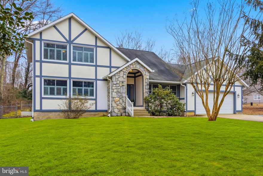 Welcome to this beautifully maintained 5 bed, 4.5 bath, colonial home situated on almost a half of acre and only 2 blocks to the Chesapeake Bay where you can hear the sounds of the ships passing by in your backyard!  Located in the very desirable and relaxed Oyster Harbor Community. This move-in ready home features: over 3,100 finished sqft, 2 primary suites with private full baths which makes it perfect for multigenerational living. The main level is filled with natural light, cathedral ceilings, and an open layout. The main level primary suite offers a spacious bedroom with costume shutters, a walk-in closet with extra room for storage, and a oversized walk-in shower with floor to ceiling tile, multiple shower heads, and a bench. The upper level features the second primary suite with a full bath, 2 additional bedrooms and another full bath. The huge lower level has multiple rooms including a large rec room that can fit a pool table, games and a bar area, plus a family room or theatre room, a 5th bedroom, and a full bath! There is even space for a kitchenette! The lower level has outside access which would make it perfect for an in-law suite. The backyard is fully fenced in and perfect for summertime entertaining! When spring hits you will be surrounded by green trees; the lot next to the home is a preserved lot. This home is nestled between Oyster Creek, Fishing Creek, and the Chesapeake Bay. Oyster Harbor offers the best of Coastal Maryland living—just minutes from historic downtown Annapolis, top-rated restaurants, shopping, and commuter routes. Quiet Waters Park is only minutes away with walking trails, dog park and beach, concerts, ice skating, and so much more! Walking distance to Thomas Pointe Park. The Coast Guard is just down the street. This home is MOVE-IN READY AND A MUST-SEE!