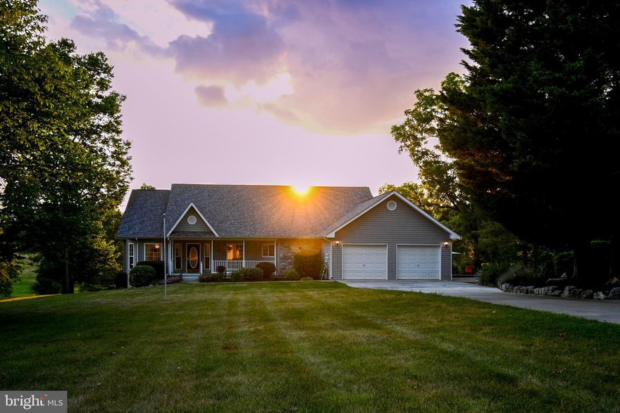 Stunning!  Welcome to this spectacular ranch style home with breathtaking views, tons to offer, and located in one of the more convenient locations in all of Berkeley County.   Five bedrooms,  three baths,  2 car attached garage and a 3 car detached garage nestled in just enough of a canopy on over an acre and a half.  As you pull in the concrete drive you'll know this is the home for you.   The professional landscape and hardscape will capture your attention before you ever get to the front door.   Walk through the threshold and be invited in by beautiful Brazilian Tigerwood flooring.   Large separate dining room to your left, spacious living  room  will peek through the hallway and catch your eye with its appeal.  A stone fireplace is the centerpiece and has large enough windows for year round views of the peacefulness.  Walk out onto the newer low maintenance deck for a better look.  Come back in to check out the kitchen.  You'll find custom soft close cabinets with several built-ins, topped with maintenance free quartz that are very easy on the eye,  an island, a pantry, and a nice breakfast nook. The stainless steel appliances are all in great condition and convey.  The kitchen is connected to the oversized 2 car garage with side door onto a 2 level hardscape with seating wall and fire pit.  Wander back into the primary suite and discover all it has to offer!  Plenty of room for big bedroom furniture, a huge walk in closet with organizers, a second walk in closet,  and a show stopping bathroom which has a extra wide vanity, and a walk in custom tile shower that includes multiple shower heads and seating.  The shower is handicap accessible.  The secondary bedrooms upstairs are of ample size and have plenty of closet space as well.  A very nice separate laundry room is found in the hallway.  The lower level has another family room with a pellet stove, two bedrooms, one bedroom has a full bath,  an extra room,  a workshop with a workbench and cabinets,  large storage area with shelving, and has windows for natural light as well as a walkout at ground level.   Walk outside and enjoy several landscaped flower beds throughout the yard on your way over to the 3 car detached garage.  The heated garage would be a perfect place for mowers, toys, storage, a hobbyist...  The garage does have a sink too, perfect to clean up before coming back in. There's an additional storage building behind this structure as well.   The roof on both the house and garage were replaced in 2020 with a 50 year architectural shingle.  House also includes a whole house water filter, water softener, and a whole house humidifier.  Come check this one out!!  A lot to offer!!!
