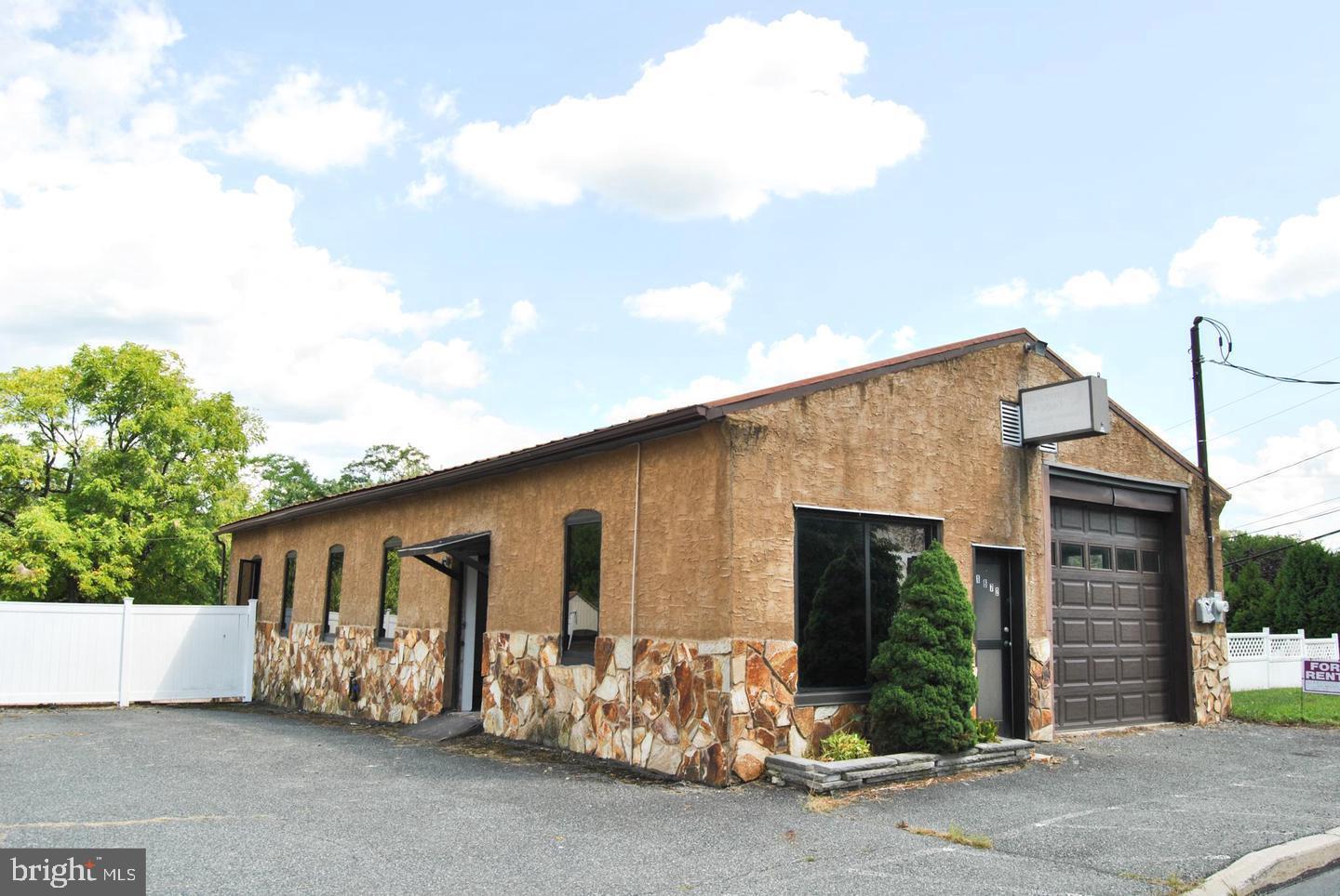 Welcome to 1067 S. Main Street, Bechtelsville, where the possibilities are only limited to your imagination! Easy access from Route 100. Be a part of Bechtelsville's growth by leasing this great commercial property. Property sits on 1/3 of an acre directly on Main Street, The first floor features two entrances, one out front right into an office/reception area and a side entrance into the main space filled with light, additional garage door access and a newly renovated bathroom. The lower level has yet another entrance with tons of storage and potential uses. There is an additional shed/garage to the left of the building with ample outdoor space as well. Property also includes fence/gate for secure parking/storage in back lot. Lease the entire property for $2,500 per month OR lease one floor/yard/lot/storage shed/garage for negotiated fee.