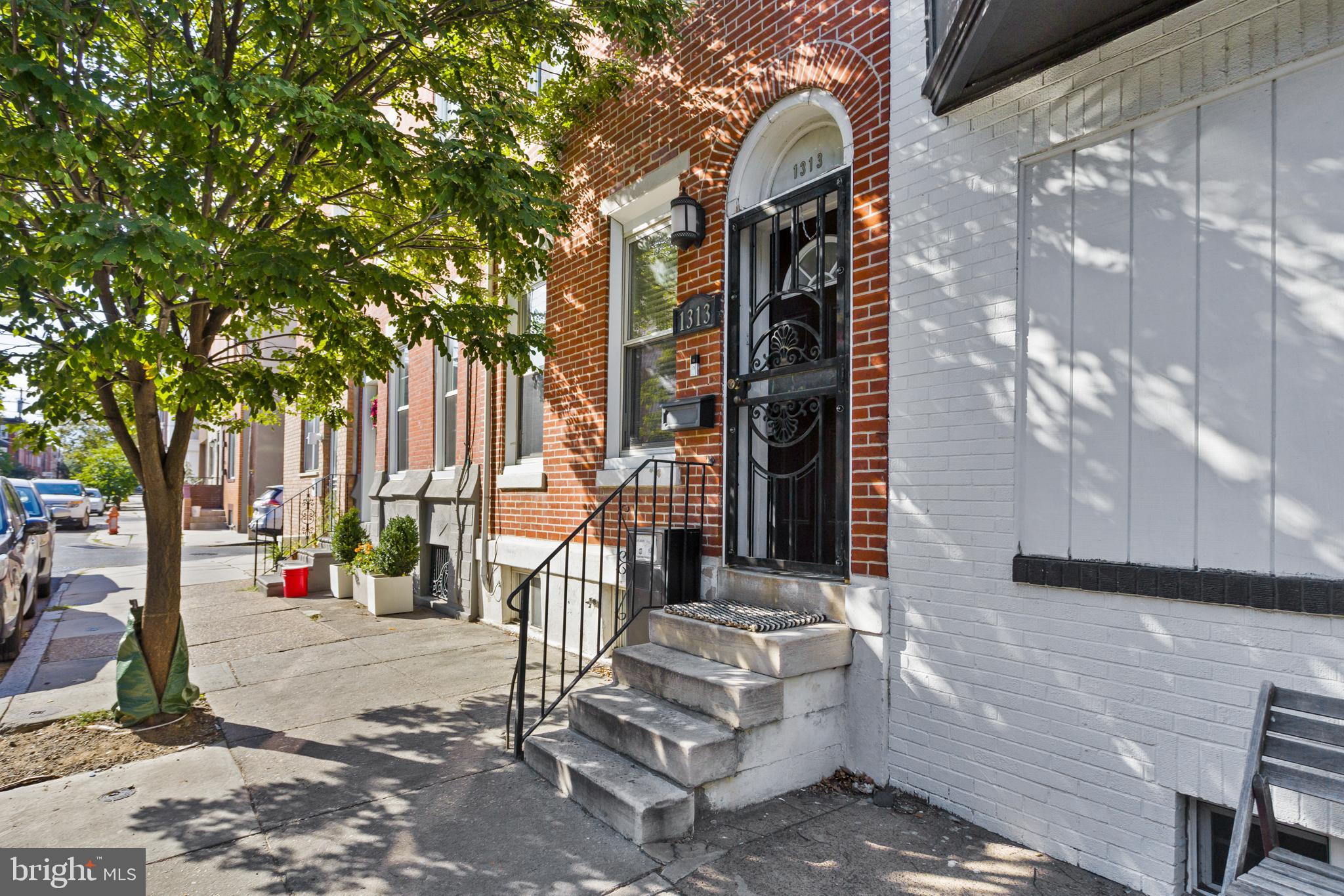 Welcome to the comfort of your new home in the highly sought-after Passyunk Square neighborhood. This beautiful three-story townhome combines modern upgrades with thoughtful design, offering both style and functionality. Upon entry, you’ll be greeted by an open-concept main level with soaring ceilings, recessed lighting, and freshly painted living and dining areas. Warm hardwood floors flow seamlessly into the eat-in kitchen area with tile flooring in kitchen, which features granite countertops, a stainless steel appliance package, recessed lighting, and a statement ceiling lamp over the breakfast nook. From the kitchen, enjoy convenient access to the rear yard as well as the basement.The partially finished basement adds versatility with new flooring, freshly painted walls, a half bath, and a dedicated laundry area.On the second floor, you’ll find the first of two spacious primary suites complete with its own ensuite bath, along with a second bedroom that has access to a full hallway bath. A hall closet on this level also houses the furnace for easy access. The third floor is home to a second primary suite with a private ensuite bath and direct access to two rooftop decks. The first deck offers a modern, multi-level design with low-maintenance finishes, a pergola providing partial shade, and plenty of space for lounging or gardening—your very own private retreat. The second rooftop deck is perfect for entertaining or unwinding, offering expansive city views and room for multiple seating and dining areas. Whether enjoying a quiet evening under the stars or hosting friends, this rooftop oasis is the perfect extension of your living space. Take advantage of all that this beautiful city offers, from its charm to its modern conveniences, and make it your own.