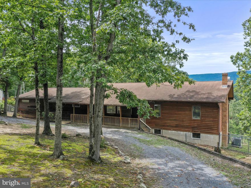 Second chance on this Spacious Ranch-Style Retreat on 5+ Acres with Mountain Views

Welcome to this beautifully updated ranch-style home offering over 5 acres of privacy, modern comforts, and sweeping mountain views. From the inviting covered front porch, step inside to a bright, open living room featuring durable LVP flooring and sliding glass doors that lead to an expansive deck—the perfect spot to take in the scenery.

The stunning eat-in kitchen is designed for both function and style, showcasing a large island, stainless steel appliances, and a commercial-grade gas range. Just off the kitchen, the main-level primary suite offers a walk-in closet, dual vanity, spa-style shower with jets, stackable laundry, and private deck access with breathtaking views. A second en suite bedroom with LVP flooring is located nearby, while three additional bedrooms and a full bath with front-loading washer and dryer complete the main level.

The semi-finished basement expands the living space with two sets of French doors opening to a lower deck and patio overlooking the mountains. A full bathroom, abundant storage, and an additional washer and dryer add convenience and flexibility.

Outside, enjoy a circular driveway, fenced backyard and side yard, plus a two-car detached garage. The entire main floor has been thoughtfully renovated, making this property move-in ready. Whether relaxing on the deck, entertaining in the spacious kitchen, or exploring the land, this home is a true mountain retreat.