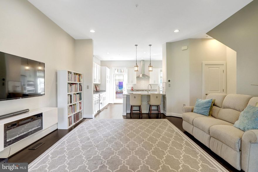 Step into 2,501 sq ft of elevated living at this 4-story executive townhome in vibrant Potomac Yard. Built in 2014, this residence blends luxury and functionality with 10’ ceilings,  Open Concept floor plan, 4 bedrooms—including a built-in office space—3 full baths, 2 half baths, and a spacious 2-car garage outfitted with Gladiator shelving and cabinets. Entertain effortlessly with multiple outdoor spaces: grill on the deck off the kitchen, soak in the sun off the  Juliet balconies, or unwind by the double-sided gas fireplace on the rooftop deck. Gardeners will love the white planter boxes that convey on the roof deck terrace—perfect for cultivating herbs, flowers, or seasonal greens in your private outdoor oasis! The 4th  floor impresses with ample built-in storage shelves, a wet bar, and a massive storage closet, while the primary suite features a custom closet system for refined organization and en-suite with oversized frameless shower and private commode!  Enjoy unbeatable walkability—just minutes to Potomac Yard Metro, Del Ray dining, Founding Farmers, Old Town, and Reagan National Airport. This is luxury living with urban convenience at its finest!