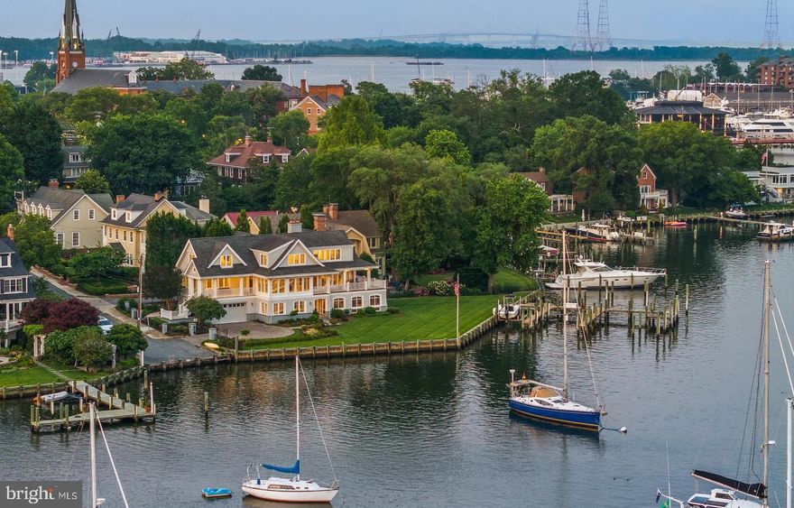 Welcome to the ultimate Spa Creek waterfront oasis! Enjoy living in the heart of historic Downtown Annapolis with walkability to everything the area has to offer including just steps to restaurants and bars, annual parades/events, Annapolis Yacht club, St. Mary's school, and water taxi pick up location. Additionally, the property boasts the only gated waterfront residence in Historic Annapolis.  Savor the sweeping south-facing views!  This exceptional property offers an intimate connection to the vibrant life on Spa Creek, where you can take in the tantalizing sunsets from the elevated vantage point and front row seats to Blue Angels show, Christmas lights parade, and fireworks. Boasting 260 feet of prime waterfrontage, it features a commercial-grade private pier designed to accommodate a 70-foot yacht, two 40-foot vessels, and provides a convenient boat lift and floating dock for launching additional water toys. This exceptional waterfront residence offers an unparalleled blend of refined luxury and architectural grandeur. From the moment you enter this timeless home, you are enveloped in natural light streaming through walls of windows that frame sweeping water views and span the main level, encompassing the living room, dining room, and grand entry. Step out onto the wraparound deck that seamlessly connects indoor and outdoor living —an ideal vantage point to savor the ever-changing vistas of Spa Creek. A thoughtfully appointed kitchen offers high-end finishes, and a conveniently located butler’s pantry, making both intimate meals and large-scale entertaining effortless. An elevator accesses all three levels, ensuring comfort and convenience throughout. The main level also features a newly renovated powder room and a private office space with endless water views, perfect for today’s work-from-home lifestyle. Anchoring the home is a dramatic architectural staircase, a sculptural centerpiece that guides you to the private upper level or the expansive lower level. Upstairs, the Primary Suite is nothing short of magnificent—an expansive retreat with panoramic water views, a private balcony, fireplace, and a luxurious layout that includes two spa-inspired bathrooms and two generous walk-in closets. An additional large guest suite also graces this level, complete with an ensuite bath and serene water views. The lower level is a haven for entertaining, with two ensuite bedrooms, a spacious family or recreation room, and a stunning custom wood bar complete with additional adjacent nautical cabinetry with wine refrigerators. The perfect set up for hosting family and friends. The pièce de résistance is the screened porch with panoramic views, grounded by a rich slate floor, and opening to a lushly landscaped yard that rolls gently to the water's edge. This is not merely a home—it is an experience. A waterfront sanctuary where timeless elegance meets modern sophistication on one of Annapolis’ most coveted stretches of shoreline. Welcome Home!