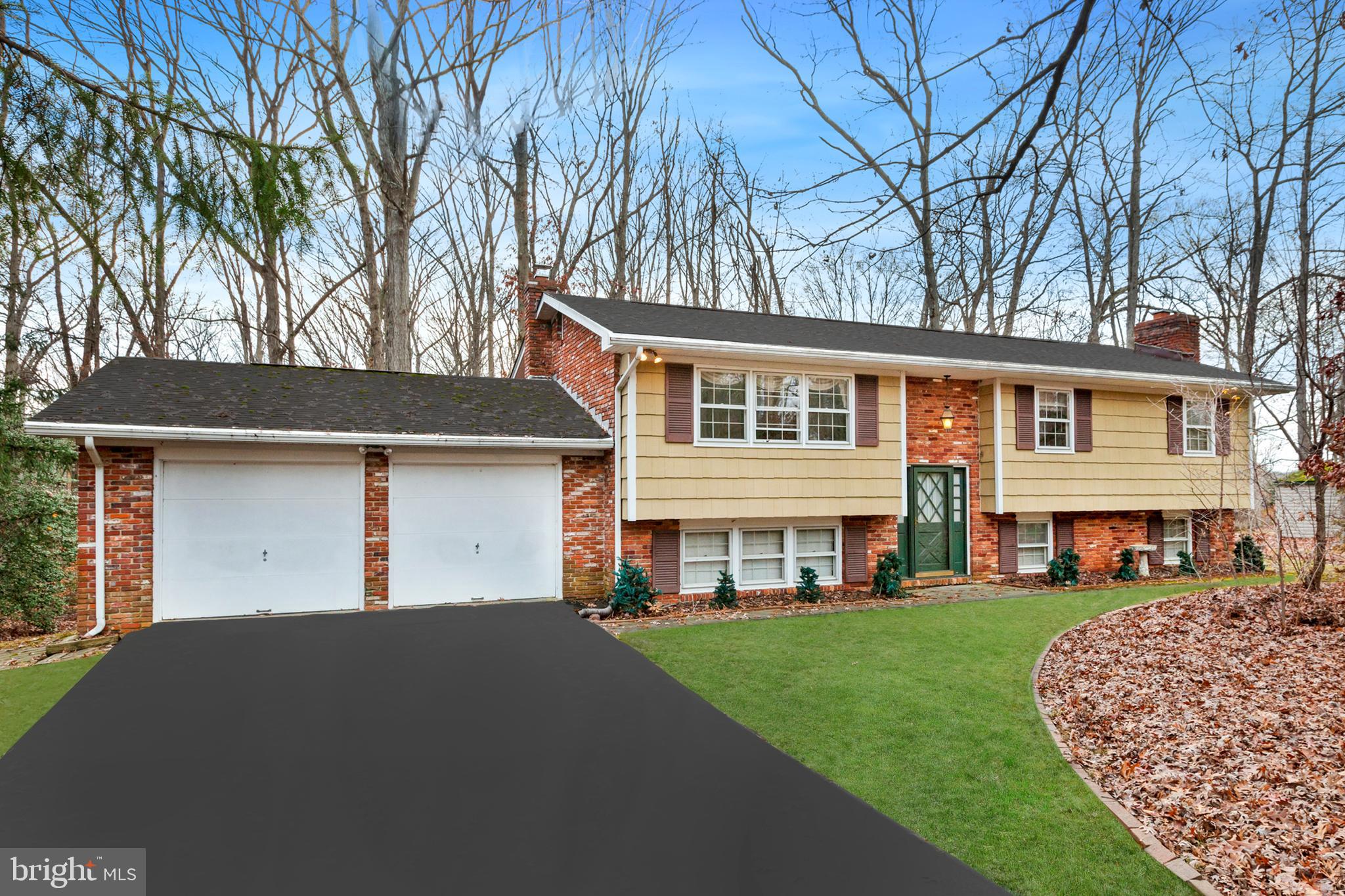 Charming 3 bedroom, 2.5 bath brick and shaker split-level home situated on a private lot surrounded by trees with a 2-car front load garage and 2,000 SF in Kenwood Farms. The main level offers a light filled, open living and dining room, kitchen with room for breakfast table and access to the rear deck overlooking the yard. Hardwood floors run throughout the living and dining space underneath the carpet into the bedrooms, including the spacious primary with private bath. Find additional living and entertaining in the spacious lower-level walkout with wood stove and brick surround, and potential for bonus space or fourth bedroom. Enjoy the tranquility of nature from the slate paver patio and rear yard of this wonderful home.