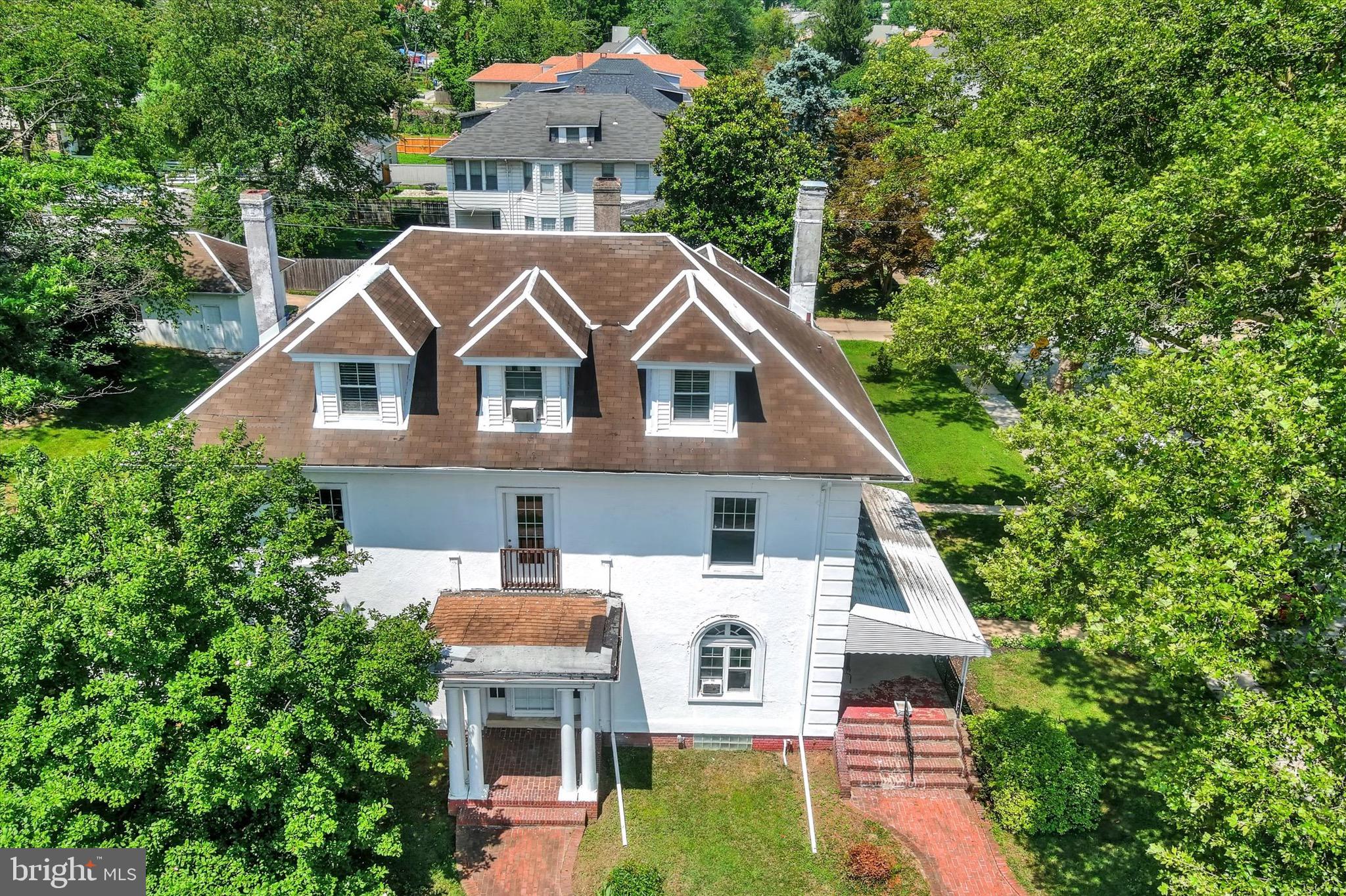 Stately lakefront Colonial overlooking a vast manmade lake and historic Hanlon Park. This grand home features a mix of beautiful and classic herringbone hardwood floors and traditional hardwood floors, sun-filled sunrooms, and elegant architectural details including large columns and a cast iron balcony. Currently configured as a 2-unit property with 5 bedrooms, 3 full baths, 2 half baths, 2 dining rooms, 2 living rooms, and a 3rd-floor bonus room with gas fireplace. Easily converted back into a sprawling single-family estate. Updates include a furnace (<10 yrs), hot water heater (2 yrs), and reverse osmosis filtration system (1 yr). Expansive hardscaping, lush grounds, and a detached 2-car garage. Minutes to shopping, Forest Park Golf Course, and directly across from Hanlon Park.