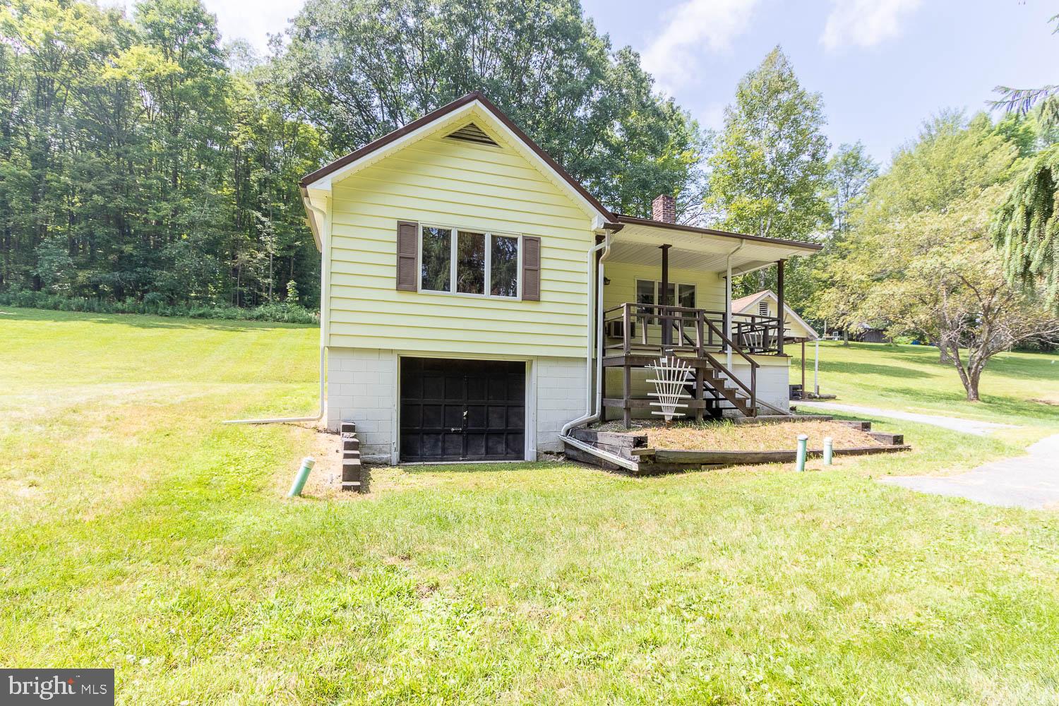 Don’t be fooled by the footprint, this charming home offers more space than meets the eye! Tucked away on a serene 2.5-acre parcel, this adorable 3–4 bedroom home blends comfort, character, and convenience.
The eat-in kitchen features ample cabinetry, perfect for casual meals and catching up with loved ones. The bright and spacious living room offers plenty of room for everyone to kick back and enjoy a quiet evening or a lively football game. Need extra space? The cozy knotty pine den makes a great office, reading nook, TV room, or even a fourth bedroom. The main floor also boasts a full bath, laundry area, and a bedroom—ideal for easy one-floor living. Upstairs, you’ll find two generously sized bedrooms with charming built-ins. The lower level offers abundant storage, a workspace for your hobbies or tools, and a convenient half bath. Enjoy the outdoors from the covered carport and patio, great for keeping your vehicle protected or relaxing in the shade. A handy storage shed and peaceful surroundings make this property even more appealing. All at an attractive price. Quiet setting, flexible layout, and loaded with potential, make this your new address today!