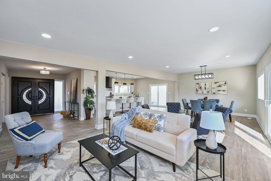 Rarely available : This exquisite 4000+ sq ft two-level rancher home is located on a wooded lot just under 1 acre on one of the 13 Premium lots in Old Court Gardens. The Sheraton Sage Green exterior brick color is one of the hottest colors in 2023. Professionally landscaped entrance, with immense curb appeal, guides you down a stone pathway towards a pair of luxurious mahogany oak double-doors. As you enter these doors, you'll immediately feel the warmth of home and your eyes will glow up looking at these interior finishes and designs. So much attention to detail on display. An open floor-plan with two sitting areas, a dining area, large windows welcoming in so much natural night, and a view of the spectacular designer kitchen. This kitchen...will blow you away. A 10-foot kitchen island, white cabinetry with black and gold accents, Quartz countertops all around, recessed lighting, pennant lighting over the island, brand new stainless steel appliances : featuring a 30-inch built-in under counter microwave, Self-cleaning induction range with Air Fry oven, premium Instaview counter-depth LG French door refrigerator with dual ice maker. Waterproof luxury vinyl flooring throughout this home. All new Eco-friendly, double-pane windows and sliding doors installed January 2023. Four spacious bedrooms on the upper level, including a primary owner's suite with generous closet space, an attached spacious bathroom with a 60 inch navy blue double-sink vanity, with gold accents, a large shower with a bench and soap niche, and an additional walk-in closet. You can also access the large Trex composite deck from the primary bedroom suite. The lower level is fully finished, with a ground-level entrance/exit, a family room with a white brick wood-burning fireplace, a home office room, 3 additional bedrooms, and a modern-style full bathroom. Brand-new set of Whirlpool washer and dryer included in the utility room. New roof installed July 2022. HVAC (2019) Windows and exterior doors (2023) Well water system recently serviced with a new holding tank, new water softener system, a UV sterilization system to fight bacteria, and a new water filter. PVC plumbing throughout the home. Close proximity to I-695, I-83, Quarry Lake, Greenspring Station.