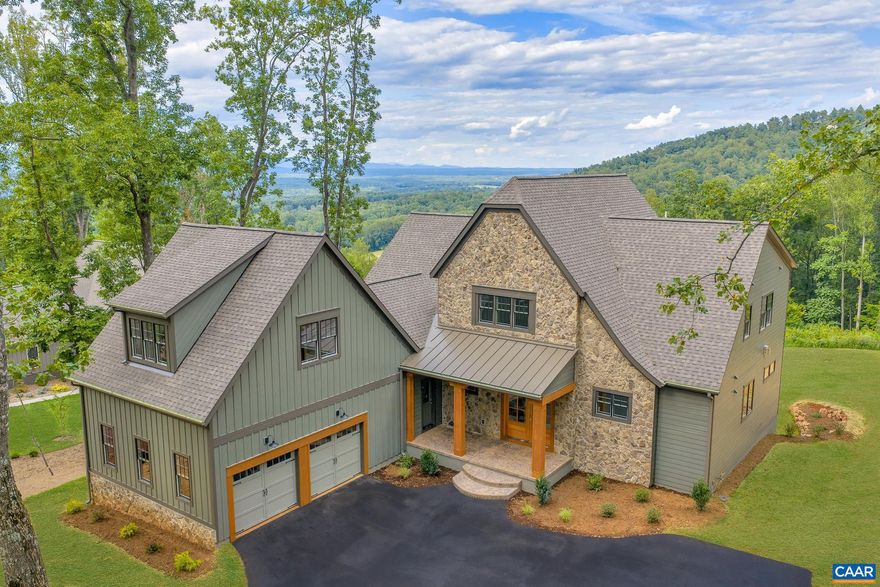 SIGNIFICANT PRICE IMPROVEMENT! Sweeping Blue Ridge panoramas take center stage throughout this artfully designed Ashcroft home. The soaring entry balances rustic warmth with refined scale, introducing the home?s signature blend of casual comfort and elevated design. The expansive Great Room with 10 ft ceilings showcases a dramatic stone fireplace flanked by custom cabinetry and opens to a chef?s kitchen designed for both beauty & function, with a statement island, sleek quartz finishes that carry from countertop to full-height backsplash.The main level primary suite exudes quiet luxury, its spa-like bath appointed with a freestanding soaking tub, custom double vanity, and elegantly tiled shower. The upper level features two spacious en suite bedrooms & a comfortable loft, while a separate Office/Flex Suite, with private stair access, full bath & kitchenette, offers an ideal space for guests, remote work, or quiet retreat. The terrace level is designed for relaxed entertaining, featuring a spacious gathering area with a custom-tiled fireplace, full bar, 4th bedroom & bath, & a walk-out patio that opens to a remarkably level backyard and sweeping mountain vistas. Experience elevated living just 10 min from Downtown Charlottesville!,Glass Front Cabinets,Maple Cabinets,Quartz Counter,White Cabinets,Fireplace in Family Room,Fireplace in Living Room