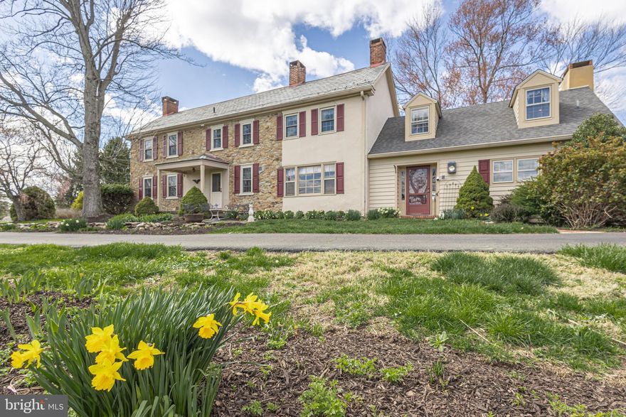 Extraordinary opportunity to own 90 acres in Central Bucks County. First time on the market in more than 75 years, the Yerkes Farm of Buckingham Township is available for the next generation of land stewards. This historic property, consisting of two tax parcels, includes a charming stone farmhouse, a detached garage, and a classic red bank barn. The preserved 80-acre parcel has been farmed for over two centuries and is eligible for continued crop cultivation, while the additional 10-acre parcel—home to the farmhouse and barn—is not under conservancy. The early 19th-century stone home retains much of its original character, with a traditional floor plan that includes formal living and dining rooms. A striking stone walk-in fireplace serves as the focal point of the eat-in kitchen. Upstairs, three bedrooms and a full bath offer comfortable living space. Period details, such as pumpkin pine floors, three fireplaces, vintage hardware, and deep window sills, create a warm, timeless appeal.  A two-story frame addition seamlessly blends with the original structure, offering a spacious family room with a wood-burning fireplace and built-in bookshelves, a laundry room, and a fourth bedroom with an ensuite full bath. Exposed stone walls, wood paneling, and other period materials in the addition ensure an attractive and cohesive design. Enjoy peaceful views of the farm from the large, screened-in porch—perfect for relaxing and entertaining.
The quintessential red bank barn, over 4,000 square feet in size, features a distinctive open forebay with tapered concrete columns. The second floor, traditionally used for hay and farm equipment, offers additional space for storage or as a venue for gatherings. The two-car detached garage provides ample parking, while mature shade trees and shrubs ensure year-round beauty. Conveniently located with easy access to Doylestown, New Hope, and Newtown, this exceptional property offers a rare chance to own a piece of Bucks County history. Don’t miss this once-in-a-lifetime opportunity for this exceptional farm.