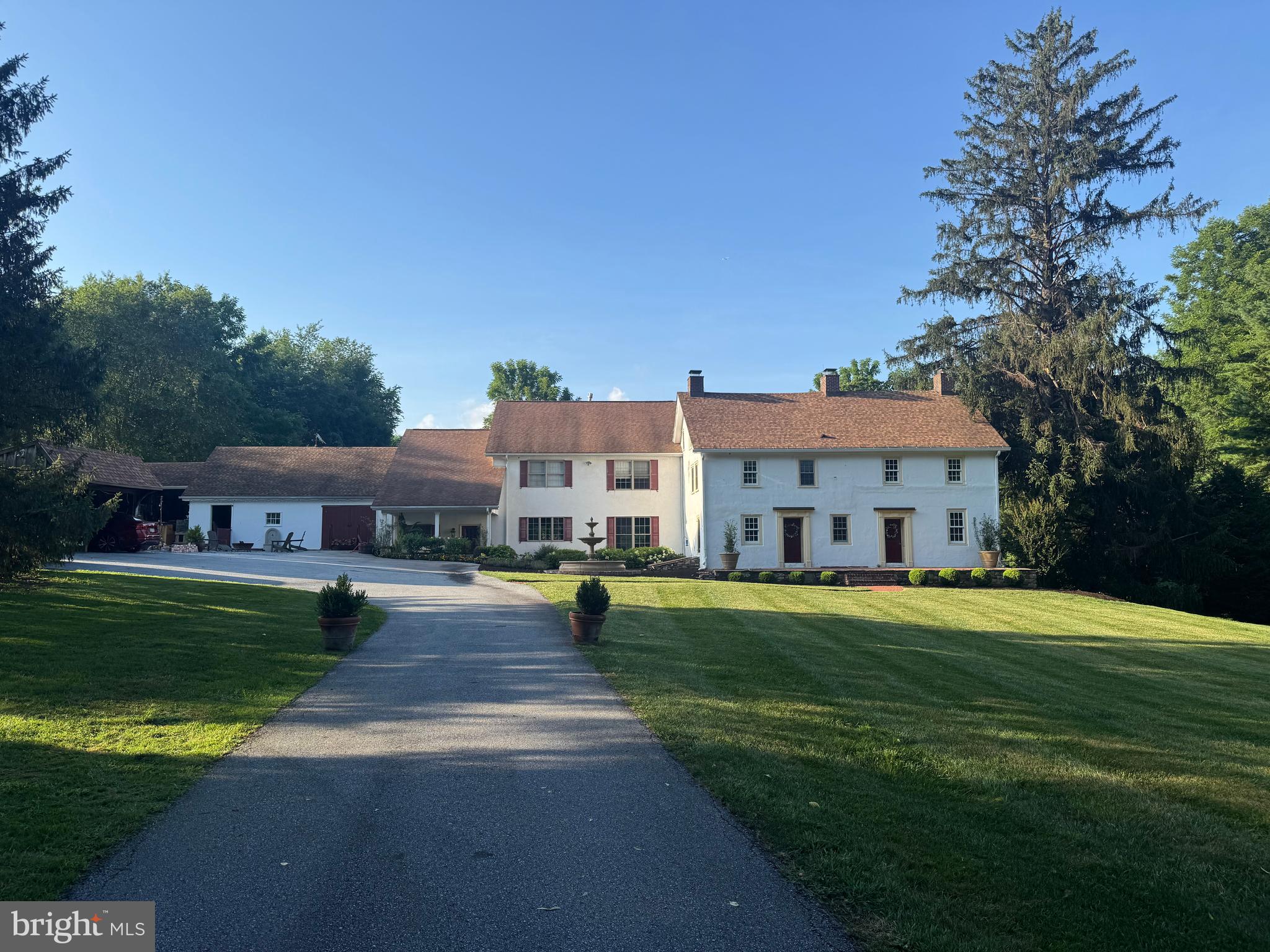 This beautiful, gated estate is a classic example of an historic Chester County farmhouse, nestled on 2.35 acres with an additional adjacent 2.29-acre parcel (buildable lot)—totaling 4.64 acres of pristine grounds—next to 8 acres of open space. There are also ponds and wetlands visible from the grounds, notably in the fall, winter, and spring. Immediately upon entry through the electronic artisan-built Sapele wood gates feels like stepping back into time. The lawns, fountains and plantings (e.g., rose garden and pollinating garden) set the tone of a Longwood Gardens-inspired atmosphere and three-section home. The 1746 and 1850’s stone sections of the home have been lovingly brought up to today's standard without losing their historic charm. For example, these sections include new wood fireplace mantels and paneling (milled by Tim Flegal from HGTV) and marble windowsills. The recently added section circa 2009 boasts a great room with 9ft ceilings, a chef’s kitchen with stone counter tops, and integrated appliances (2 cabinet front dishwashers, Cabinet front refrigerator, double ovens, an in counter deep fryer and a 6-burner gas Wolf cook top). The spacious pantry has a subzero fridge. Additionally, this section has exposed wood beams, exposed stone walls, huge picture glass windows with views of a back yard reminiscent of Longwood gardens. Each section of the home is integrated into the next, with a unique flow throughout the house on the first floor and the 2nd floor. By the way, the world-renowned Longwood Gardens is a mere 5 minutes away. And watch Longwood Fireworks from your yard at he top of the property, And dark night sky often clear enough to the meteor showers.