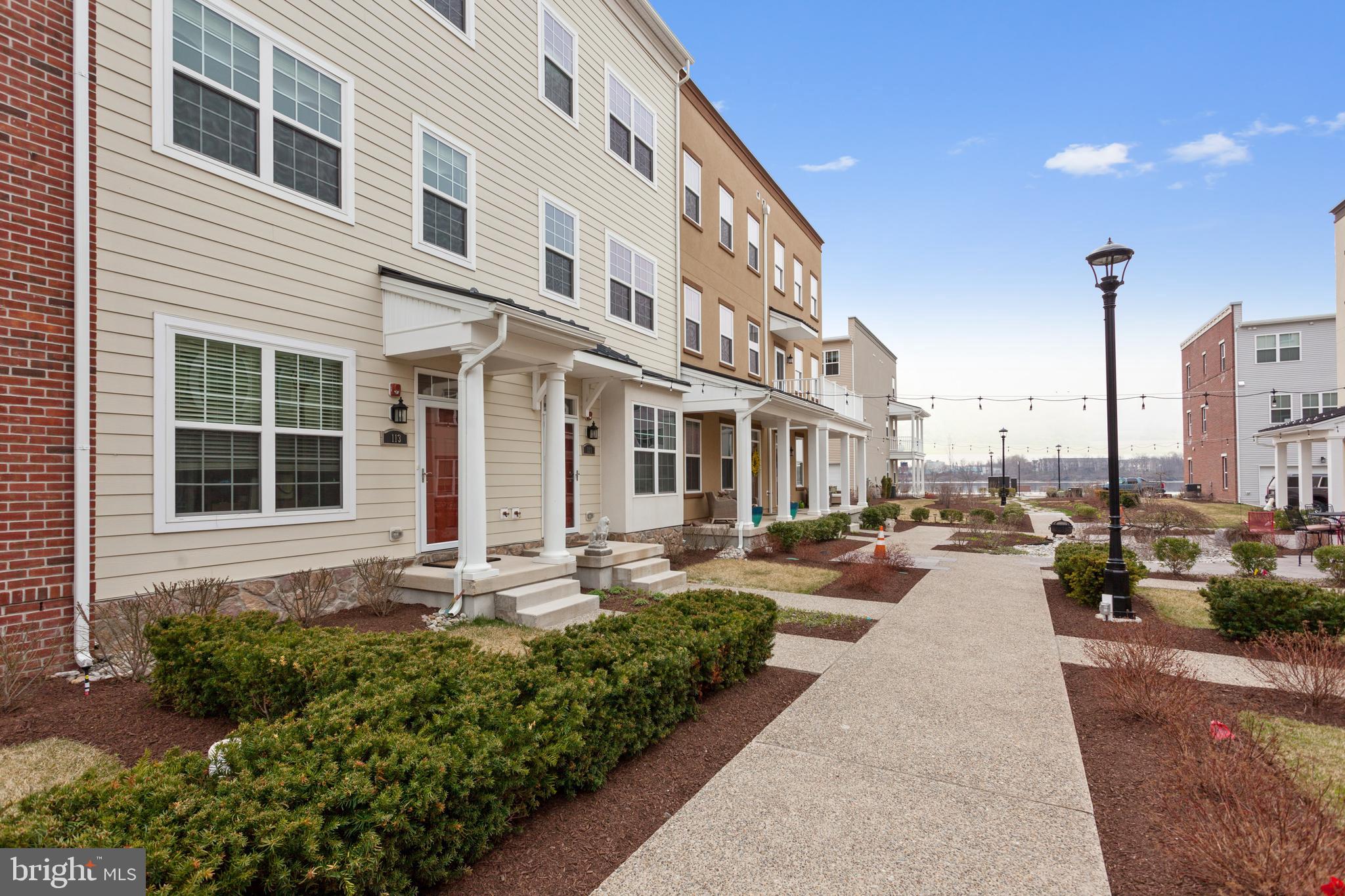 Welcome to Waterside, a desirable recently constructed townhome community located right on the Delaware River front! This 3 bed 2 full bath 2 half bath is an Alexandria Lofts model with an ELEVATOR located on the Mews which is arguably one of the most desirable strips in the community. As you enter your new home the first floor welcomes you with a den/study, a laundry area, and inside access to your 1-car garage. As you walk up the stairs (or ride your elevator) you'll immediately notice the beautiful, spacious kitchen with large peninsula, mocha cabinets, granite counters, and tile backsplash. Off the kitchen is one of two decks that's great for morning coffee. As you pass through the kitchen you have both a dining area and large living space. Take note of the wood flooring, the recessed lighting, and the tasteful accent walls. The 3rd floor is home to two sizable bedrooms with generous closet space (one with an en suite bathroom) + an additional well appointed full hallway bath. The 4th floor features the loft which adds versatility and can act as the third bedroom, an additional living space, a play room, etc. Off the loft is your second deck with lovely views of the River (not a bad way to wake up!). This home has many upgrades from the standard (too many to name) and provides quick access to I-95 and Cornwells Heights Train Station making it very convenient for work commutes!