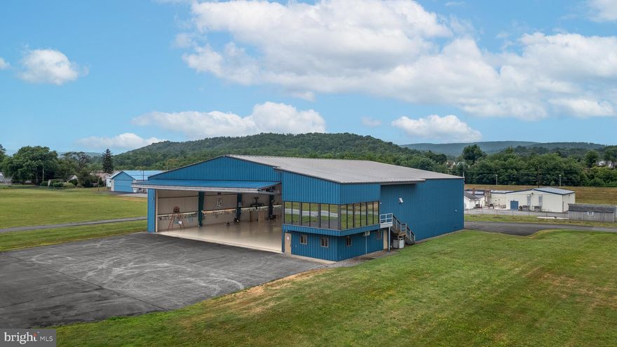 A rare opportunity to own a pristine hangar at William T. Piper Memorial Airport in Lock Haven, PA. Spanning over 13,000 square feet, this impressive facility can house multiple aircraft with room to maneuver, featuring an 80' x 20' front door and a 60' x 20' rear door for easy access. The building is fully insulated and heated with two industrial gas heaters, while the attached tower/bunker provides versatile space including a shop area, living quarters with a kitchen and full bath, and a loft ideal for bunkhouse accommodations, all equipped with a gas heat pump and central A/C. The airport offers two parallel runways with 24/7 access and is home to AvSports of Lock Haven flight school and the Piper Aviation Museum. Conveniently located less than an hour from Penn State University, this property is perfect for aviation enthusiasts, flight operations, or business ventures seeking a prime central Pennsylvania location.