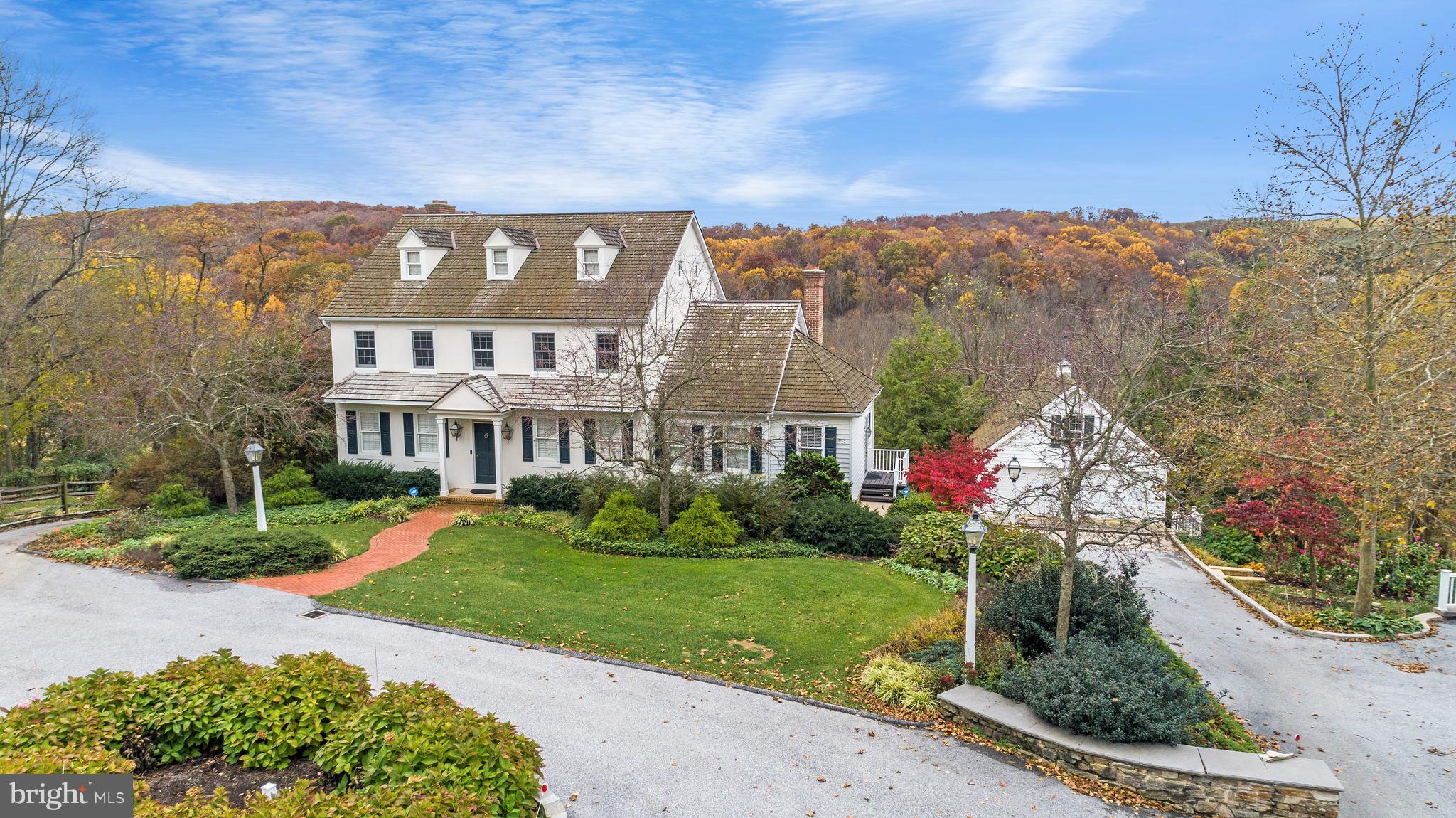 This is truly a unique opportunity to own a very special Home/Farmette in York County. This home offers understated elegance, warmth and sophistication in a perfect location with pastures, trails,  woods and ponds.  The main house offers 4,000+sf of living space with 4 Bedrooms, 3.5 Baths,  Living Room, Dining Room, Entry Foyer, Kitchen with eating area and Family Room, Mud Room, Laundry Room and Powder Room, all with exceptional hardwood flooring, custom millwork and built-ins. Step into the center of the home to the spectacular Chefs Kitchen that is centered between a Dining Area with vaulted ceilings and fireplace at one end, Family Room with fireplace at the other end, all with walls of windows leading to the covered porch with panoramic views of the countryside.  The Kitchen offers stainless steel appliances, crisp white custom cabinetry, oversized farm sink, soapstone countertops.   The Upper Level is home to the Master Bedroom with two walk-in closets, Fireplace, Window Seat and spacious full Bath.  The walk-up attic is accessed from the Master Bath with potential for further finished space.  Bedrooms 2 and 3 share a full bath completing the Upper Level.  The walk-out Lower Level with views of the pastures, ponds and fields has a large Bedroom, Full Bath with Steam Shower, Family Room with an area that could be converted to a kitchen, storage room perfect for a wine cellar.  Outside Buildings include: Detached 2 car garage perfect to be converted to a Guest House, heated dog kennels, heated 6 bay detached garage with 3 bays on top, 3 bays below has water, half-bath, upper level storage, amazing 4 Horse Stall Barn with Tack Room, electric, running water. There are riding trails that extend for several miles.  An amazing property in details, modern amenities, maintained to perfection.  With the ideal location of less than 10 minutes to hospitals, shopping, I-83 and located in Dallastown School District.  This is truly the perfect home for entertaining inside and outside for a family of any size.