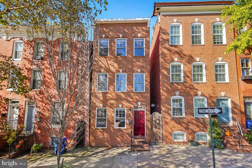 The house was completely re-constructed from the ground in 2018. The 4-level house offers 5-bedrooms, 4-full bathrooms, and a half bathroom. Fresh Paint. New Carpet. Two zone HVAC. The roof deck was freshly-painted and it features 360-views of Baltimore's skyline. A detached garage is at the back of the house. The seller has  redeemed the ground rent recently. The fire sprinkler system has been in place and just need to be installed and activated. The main level is decorated with solid hardwood floors. There is a spacious living room with a beam-ceiling, chair railings, crown moldings in the front and a beautiful chef's kitchen at the back. The kitchen boasts granite countertops, solid wood white cabinets, ceramic tile backsplash, gas cooking, built-in microwave, dishwasher and garbage disposal. The kitchen door leads to the outside concrete floor, fenced backyard and the 1-car detached garage. The second level has a primary bedroom and an attached primary bathroom. The other two bedrooms share a full bathroom. The third level features two spacious bedrooms, both with private baths. All 5 bedrooms have a walk-in-closet and ceiling fan. All 4 full bathrooms have a bath tub, granite countertop, ceramic tile floor and the wall. The roof deck of the house provides a wonderful view from the top. The unfinished large basement has a french drain system and sump pump installed, plus plenty of space for storage. This is an ideal home for a large family. A perfect location, easy access to restaurant and cafe shops; Johns Hopkins University, downtown, Canton, Fells Point and I-95.  Close to harbor and only 1 block to Patterson Park - ideal for City living.