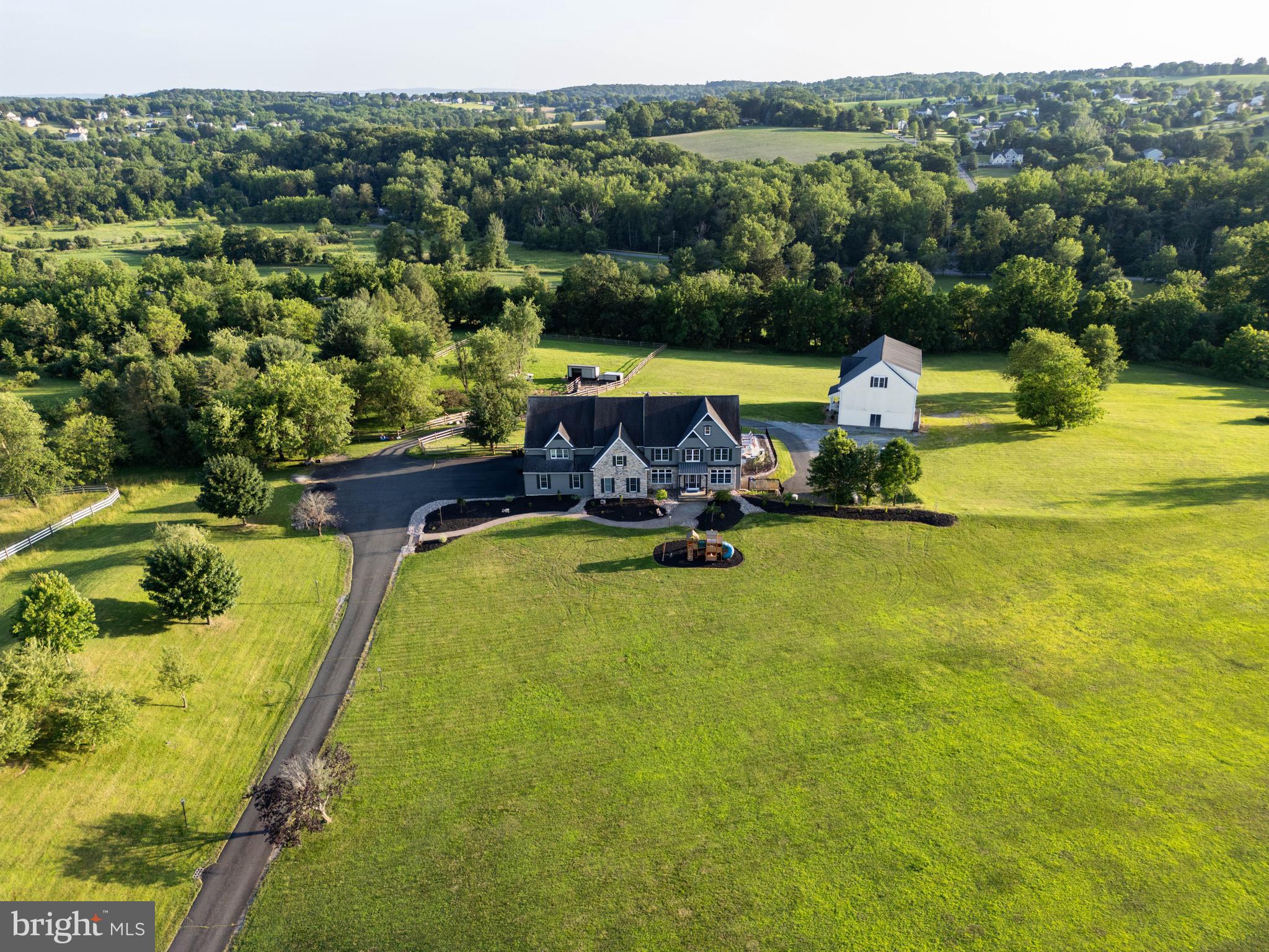Estate Living Meets Designer Luxury on 11+ Acres! Welcome to Hamilton Green - a one-of-a-kind property in Bushkill Township, where style meets substance. This expansive estate spans over 11 acres and features a completely renovated Colonial-style main residence, updated top to bottom by Pottery Barn’s design team. Every detail has been elevated—from custom finishes to fully upgraded bathrooms—offering a warm, modern elegance throughout. The main home offers 7 bedrooms and 5 bathrooms, including a private in-law suite. A grand foyer, multiple living and dining spaces, sunroom, fireplace, and finished lower level ensure ample room for living and entertaining. Enjoy the outdoors with a brand-new inground pool, outdoor kitchen, and poolside bathroom, all set against serene, tree-lined views. The property also includes a separate 5,000 sq ft guest home featuring two independent apartments totaling 7 additional bedrooms and 4 baths—perfect for extended family, guests, or income opportunities. With 8 garage bays (5 attached, 3 in the detached 4-story building) and a whole-house propane generator, this estate is as functional as it is beautiful. Recently appraised at $3M—an extraordinary value for a truly turn-key estate.