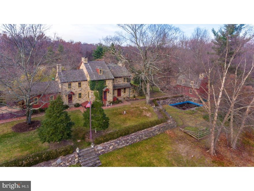 With the impressive distinction of being among the very earliest settlements in Pennsylvania, Pheasant Hill Farm is arguably one of Bucks County's finest treasures. Situated on ten acres (with an adjoining parcel of 37 acres also available), this quintessential country estate has only changed owners a handful of times in more than 300 years, so its rustic charm and old-world character remain completely unspoiled, making it one of the most significant properties to come on the market in a generation. A long, bowered driveway, flanked on either side with split-rail fencing, passes under a shady grove that opens to a dazzling hill-top retreat, perfectly private, but with truly breathtaking views of the Delaware River valley and the rolling hills of New Jersey beyond.  To the west, holding court at the center of this collection of 18th century buildings is the 3-story main house, with fieldstone walls, vaulted rooflines and gable-end chimneys reminiscent of the property's colonial beginnings. Inside, you'll find 4 bedrooms, 3 baths, an eat-in kitchen, a formal dining room, a sun room, 2 drawing rooms, and a cozy tavern (complete with a brass-topped bar). Lovingly-maintained details abound: polished wide-plank floors, walls of stone and hand-troweled plaster, original woodwork, lead-glass window panes, hand-forged iron hardware, detailed stenciling, and fireplaces almost too numerous to count, including an arched walk-in fireplace in the kitchen. Just outside, an Amish greenhouse watches over a classic kitchen garden, with brick-lined walkways, and a series of raised beds for vegetables and flowers. Extending out from the house to the east is a handsome lawn with stately hedges and stacked stone walls that step down to an open field. At the far end of the lawn, overlooking a grotto-style plunge pool, is the 2-story guest cottage, with its own living area, sleeping alcove, kitchen, bedroom, bath, and walk-in cedar closet. To the west of the main house are twin timber frame and stone barns, the first of which has been transformed into a stunning living space with a vaulted ceiling, exposed beams and 20-foot tall windows, perfect for an artist's studio, gym, office, or home theater. The second barn maintains its original character with giant doors and towering stone walls, making it an ideal setting for open-air dinners. Yet another smaller barn opposite the kitchen garden provides more space for storing bikes, sleds, outdoor furniture, and gardening supplies.