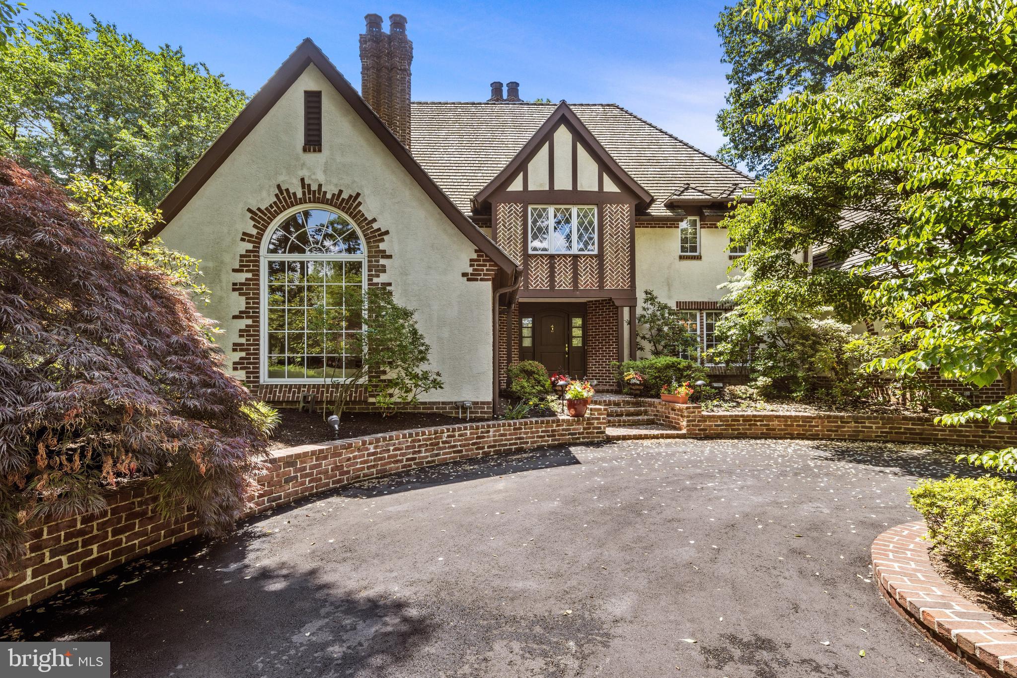Welcome to the “One of a Kind” Custom Tudor Home in Prestigious Villanova. This wonderful home is situated on a picturesque 1.33 acre lot offering an abundance of privacy and exquisite landscaping. The exterior of this elegant home features a circular driveway and beautiful architectural details. This “One of a Kind” home has a rear patio with awning that is very inviting and creates a sense of Tranquility. This property has been meticulously maintained inside and outside. 705 Cedar Lane offers 4 bedrooms and 3 ½ baths. Exquisite craftsmanship throughout with detailed moldings and millwork. 2 Fireplaces, Beautiful pegged hardwood Floors and also a much sought after bedroom suite on the main level. The Bedroom Suite on the Main Level features a large Bathroom and generous closet Spaces. On the Second Level you will find a Large Main Bedroom suite with abundant closet spaces and lovely Au-suite bathroom. Two other bedrooms on this level with a Jack and Jill Bathroom. Highlights include: a large great room with Fireplace (gas insert) Cathedral Ceiling with Trusses and Built-in wet bar. A Gourmet Kitchen that would delight any chef with it’s Custom Cabinetry, Granite Countertops, Sub-zero refrigerator and separate full size Sub-zero Freezer; Bosch 5 burner gas range, along with 2 Bosh wall ovens and Bosh dishwasher, Microwave and Wine Cooler. The kitchen also features a Center Island and a generous Breakfast room area with French Doors that lead out to the inviting patio which is perfect for dining “Al Fresco”. The Living Room features 15 ft. ceilings, large Palladium window and wood burning fireplace. Large Formal Dining Room perfect for Holiday Festivities. Powder Room on this Main Level. The flow to the Floor Plan and The magnificent outdoor spaces make this home a perfect place for entertaining . The lower level is finished and perfect for an At Home Gym or Recreation Room. Large full Attic with easy access staircase and over-sized cedar closet for storage. 3 zone Heating system (3 electric heat pumps, 2 of which have gas back-ups, 1 with electric back-up). Laundry Room on Main Level with LG washer and dryer. For an added bonus, there are 2 Electric Vehicle charging stations in the garage! This convenient location is within minutes of Villanova train station, King of Prussia Mall, Bryn Mawr and Suburban Square in Ardmore. Close to all major highways and located in the Award Winning Lower Merion School District.