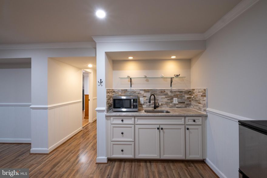 *** RENT INCLUDES WIFI and ALL UTILITIES!! *** BEAUTIFULLY MAINTAINED, LIGHT-FILLED, and optional partially furnished BASEMENT APARTMENT IMMEDIATELY AVAILABLE - 600 sq ft, 1 bedroom, 1 full bath, living room with dining area, and a kitchenette equipped with an electric double burner, microwave, and refrigerator. Washer/dryer in unit. Quiet neighborhood with a private stone path to a separate entrance. Parking is available in the driveway. Walking distance to shops and dining, less than 10 minutes from GMU, and a short commute to Vienna Metro Station. **NO PETS**