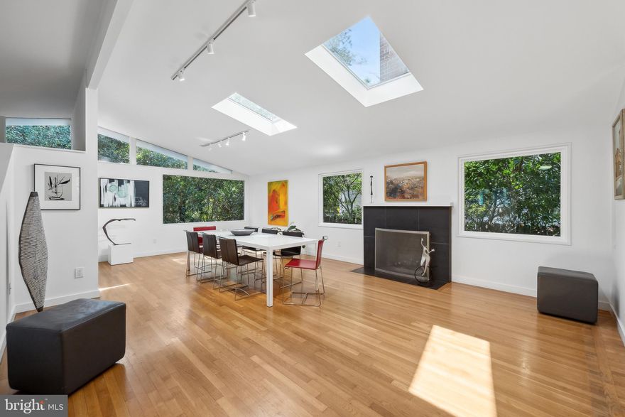Tucked away in the heart of Garrett Park and designed by award-winning DC architect Suzane Reatig, this strikingly modern home offers a serene, light-filled retreat with a flexible floor plan to suit a range of lifestyles. From its soaring 16’ ceilings and clerestory windows to the expansive walls of glass, skylights, and oversized windows, light and air flow through every room, creating an open and tranquil ambiance. The home’s connection to the outdoors is unmatched, with seamless views of the sky and yard from nearly every angle. This thoughtful design fosters a perfect setting for daily comfort and large-scale entertaining.  The flow from the terrace-level family room to the expansive patio with a built-in gas grill is exceptional. Working from home has never been so worthy in the main level office that overlooks both the yard and the family room below.  

Significant updates completed over the years enhance the home’s style and functionality. The kitchen, updated in 2004, features granite countertops, custom cabinetry, and high-quality appliances such as a GE gas stove and Kenmore refrigerator. The luxurious owner’s suite, completed in 2008, boasts Porcelanosa tiles, Kohler fixtures, and a Porcher soaking tub for ultimate relaxation. The most recent improvements include the terrace-level entertaining kitchenette, a sleek new bath on that floor, and a new roof in 2024, ensuring years of worry-free living.   

Set on a quiet, no-thru street, this property is ideally situated in one of Garrett Park's sweetest spots. The yard was professionally landscaped and is fully fenced terminating at a metal gate at the driveway with an expansive parking pad.  Just steps away are the community playground, dog park, and the lively neighborhood pool. The town offers a true sense of community, with many children attending the nearby nursery and elementary schools, all within walking distance. Residents also enjoy the local favorite Black Market restaurant, adding to the town’s charm. Adjacent to Rock Creek Park, the location is perfect for outdoor enthusiasts, with walking and biking trails just moments away—especially on weekends when the roads are closed to cars. This home offers the ideal blend of privacy, community, and convenience, making it a truly exceptional offering in Garrett Park.