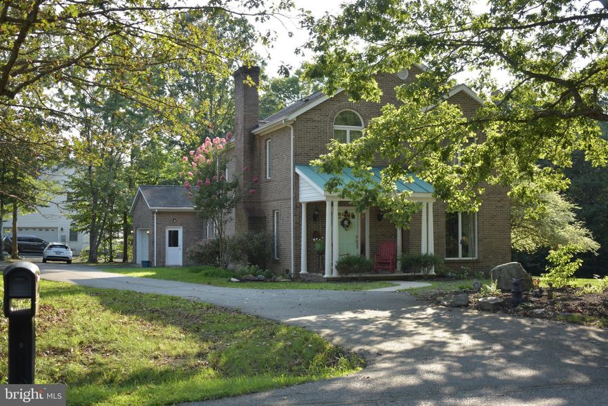 Back on market so now is your chance to own this beautiful brick contemporary home on 1+ acre lot. Open floor plan with beautiful HW floors through most of the home. Combination LR/DR with white-washed brick fireplace. First level bedroom can be an office/flex space. There is also a formal living room/flex space on main level.  Eat-in-kitchen features center island with gas cooktop, granite counters , new light fixtures and cherry cabinets. Upstairs you will find two spacious guest bedrooms with abundant closet space, as well as laundry and a full bath. Master has hardwood floors, large WIC and luxury bath with tiled floors,  double sinks, soaker tub and walk-in shower with multiple jet shower tower. The exterior of the home is a serene oasis, surrounded by mature trees and beautiful landscaping. Home has also had extensive maintenance/updates done. New chimney flue,  deck has been enlarged and new railings added, crawl space sealed and more insulation added to entire length of the house, replaced and added insulation to attic. Current owners have contract with Terminix for four years, for rolling and aerating the lawn, seeding and monthly weed treatment ($87/mo), as well as contract with Moxie Pest Control for control of mosquitoes,wasps, hornets etc ($149/quarter). Come see this beauty today!