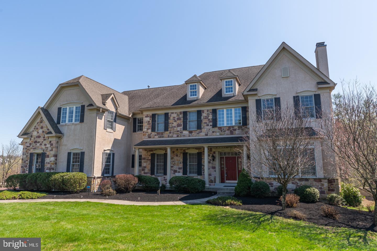 Looking for a Quality Home in a Super School District? Then head over to this stunning residence located in the highly rated Wissahickon School District. Your entire family will enjoy the splendor & comfort in this prestigious 5 bedroom, 4 baths & 2 half baths stone manor home located in the popularTrewellyn Crossing community in Lower Gwynedd township. This home is set on the best lot in the community in a serene setting with mature trees and on a cul d' sac which overlooks a scenic parklike setting. Exercise everyday on the wonderful neighborhood walking trail. This home has over 7500+ sq. ft. of living space which includes the Amazing walkout finished lower level with sparkling wood like floors thru out and recessed lights, media room, exercise room, billiard room, food prep area, a large wet bar great for entertaining with friends, music nook. bedroom with full bath plus great storage space. Greet your friends on the covered front porch and lead them into the grand front to back foyer and view the stunning architectural design with volume ceilings, beautiful woodwork details, with columns, arched doorways, sparkling hardwood floors t/o, upgraded lighting and sun filled rooms including the gracious living room and grand formal dining room. The customized gourmet kitchen has stunning cabinetry with beautiful millwork, an oversized island, granite counters and ceramic tile backsplash, butler prep area, stainless steel appliances including a double oven and stainless steel faucet above the stove, pantry and a separate breakfast room with a wall of windows and enjoy morning coffee on the expanded wood deck and view the tranquil wooded setting. Kitchen is opened to the spacious vaulted great room with back staircase, wet bar, the private library, powder rooms, mudroom and 3 car garage completes the first floor. The upper level has a master suite with a sitting room, wonderful private dressing area and double door entry to an elegant bath, and great closet spaces. There are three other spacious bedrooms including a princess suite with private bath and a shared Jack and Jill bath between the other bedrooms. Great location and just steps away from great shopping and restaurants, including Trader Joes, Starbucks, Whole Foods and much more! Easy access to 309, turnpike and train station. This home has it all. Call agent for more details too many upgrades to list here.