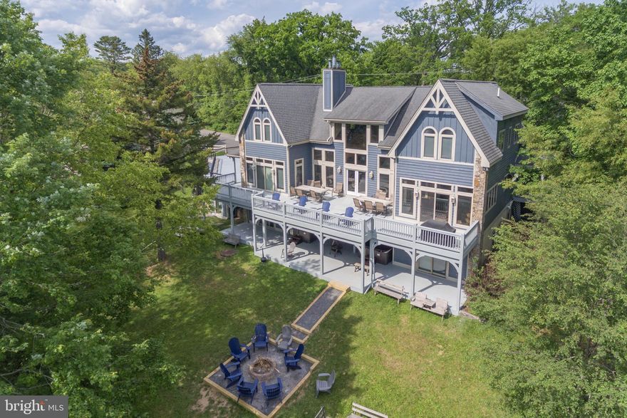 Traditional lakefront estate with 2 boat slips, 8 bedrooms, 7.5 baths, hot tub, and indoor pool! This recently updated home features natural stone and wood accents, an open floor plan, and filtered lake views.  Inside, there is New Carpet and Furniture in the Main Living area with New Dining chairs and Bar stools in the Kitchen. Main level suite has all new furniture and the 5 additional bedroom suites make it easy to host friends and family for a weekend at the lake. Fresh coat of exterior paint and Roof and Decks have been power washed. This established vacation rental is a favorite among travelers and is a great investment opportunity! Rounding out 2021 with right at $250,000 in rental income and already over $150,000 on the books for next year.  Call today for more info!