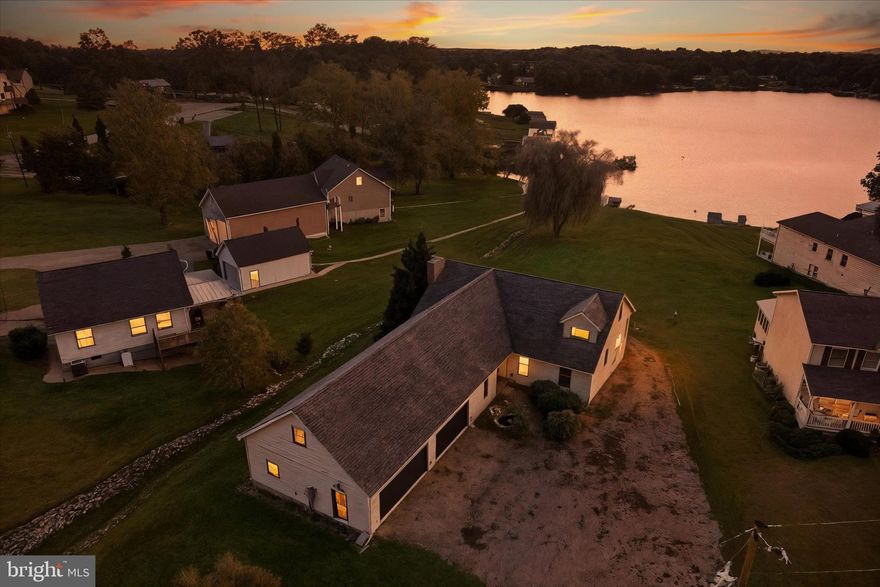 Welcome to 400 Lake Meade Drive, East Berlin.  This waterfront home is located on Lake Meade and is waiting for the new owner to enjoy all it has to offer.   There are a few remaining projects on the inside that the seller must complete.    Over 4,000 square feet of finished living space with a 2nd lower-level kitchen and a walkout to your waterfront lakeside.   5-6 bedrooms, 2.5 baths, and a very spacious family room with a bar and a pool table.   The current owners have made many interior upgrades to their home and feel this is the time to offer it to a new owner.   As you walk in the front door, you will feel the warmth that this home has to offer.   Spacious kitchen with new countertops and all appliances included.   The center island in the kitchen provides extra counter space, and there is room for your dining room table with a view of the lake.   The laundry room is located on the main level of this terrific home with a half bath.    There is a bedroom and a full bath on the main level, as well as an additional room for an office or workout room with a lake view!   As you take the stairs to the second level of the home, you will find a primary bedroom, a full bath with a soaking tub, and a walk-in shower.   A full wall of closet space as well.   The lower level (includes 2 sets of sliding doors on the lake side) offers a second kitchen, a walk-in closet, 2 additional bedrooms, a full bath with a tub/shower, plus a bonus room that could be used for an office that has a water view!   2 separate utility rooms for mechanicals on the lower level.  This is a fantastic space for in-laws, extended family, and friends, as it offers a separate entrance and a driveway that conveniently wraps around the home.  The attached 2-car oversized garage is large enough for boat storage and your vehicle, with plenty of additional storage space.   Above the garage, there are two additional rooms that could be finished to your specifications.   
Enjoy sitting under the willow tree on the lakeside as you unwind from your day!   The floating dock comes with this property and is currently shared use with the neighbor.   Call your agent and schedule a tour today!