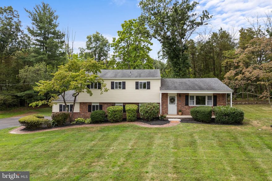 Outdoor enthusiasts and anyone loving peace, quiet and natural beauty, you just found your dream home at 3106 Kingward Rd! This 3 bed, 2.5 bath split level with hardwood floors, updated kitchen, screened porch, an oversized 2 car garage, C/A, a pellet stove, a quiet neighborhood, all sitting on a sloping 1.4 acre lot that is rare to find! Your next home is literally a short walk or bike ride from the intersections of the Blue and Red Trails on the Green Lane Park Reservoir Loop! As you enter your next home you will be greeted by a beautiful covered front porch and a main level foyer that opens to your living room. The living room and dining room have been newly carpeted and are very large, light and open with fantastic front and side yard views. The completely renovated E/I kitchen (2020) features quartz countertops, stainless steel appliances, efficient storage in your cherry cabinetry, plus an amazing view of your serene backyard! On the lower level you will find a versatile family room with brick fireplace with pellet stove insert that warms up chilly fall and winter days! The family room provides sliding glass door access to your: spacious covered and screened patio, laundry room (including washer, dryer and laundry sink), powder room, a two car garage, and a bonus room that could be utilized as an office, craft room, play room, and more! Your spotless garage has been freshly painted and features pull down stairs for easy access to floored attic storage. Heading upstairs you will find beautiful hardwood floors throughout the entire upstairs hall and bedrooms. Your hall bath has ceramic tile surround and floors, a tub shower and vanity. All bedrooms are spacious, but your primary bedroom is truly unique in that it is literally a suite with two rooms both with plenty of closet space and one of the spaces could be utilized as a nursery, office, exercise area and more (this is a space that is ready for you to make your own)! Plus you have the ensuite bath with ceramic tile floors, stall shower and vanity too! Outside you’ll love the gentle slope and views from the front porch and out back the screened porch is massive, with a metal roof and serene views of flora, fauna and wildlife! Your back yard also has a large storage shed hidden out back for all of your outdoor equipment, freeing up space for your cars in the garage! Your driveway is roomy enough to park 4+ cars for larger family gatherings and entertaining too! This is one turnkey home that you will not want to miss with peace, quiet, and abundance of outdoor activities plus it’s quickly accessible to Rt 309 and the NE Extension of the PA Turnpike! Roof was redone in 2014.  **Listing Agent to Provide Buyer with Home Warranty From America's Preferred Home Warranty at Settlement.** Offer Deadline of 5pm Monday 8/5/24, please present highest and best only.