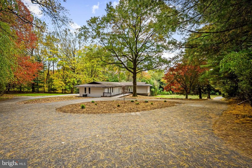 Renovated mid-century modern home blends timeless architecture with contemporary upgrades, highlighted by floor-to-ceiling glass, expansive doors, and skylights that flood the interior with natural light. Every finish has been thoughtfully chosen to honor both the original design and the natural environment surrounding this Frank Lloyd Wright–inspired 1967 raised rancher in historic Baldwin, MD. The main level showcases a custom kitchen, spa-like bathrooms, and an elegant primary suite with a private balcony, complemented by a versatile bonus room ideal for an office, den, or guest space. The layout extends seamlessly to a spacious deck overlooking nearly three acres of private woodland, offering a refined and tranquil Baltimore County retreat.