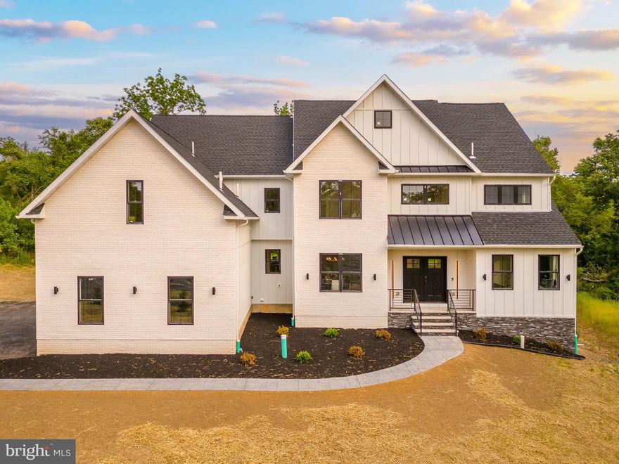 Highly anticipated and transcending all other luxury new development in the area, TENNIS POINTE stands unmatched in design and quality. A blend of Modern Colonial and Farmhouse, these FOUR avant garde  residences each offer a spacious floor plan, uniquely LUXURIOUS finishes, an entertainment-oriented finished basement and other BESPOKE details that call upon only the most sophisticated buyers. 962 Tennis Ave stands as the model home at TENNIS POINTE.  Undeniably extraordinary  upon first glance, sitting atop a raised elevation is this stunning residence clad in a white facade with black accents.  Make your way up the pedestrian path leading to the limestone porch. Through the double doors enter the towering foyer. Notice the floors fitted with Long Leaf Acacia hardwood surrounding the stunning central staircase. On your right is the living room with an ample array of windows offering natural lighting, intricate trim work and most notably a beautiful gas fireplace, laden in floor-to-ceiling marble.  Across the foyer sits the formal dining room, an accent wall brings contrast to the space.  You will find a butler's pantry as you make your way into the kitchen.  The first of three main focal points of the home, the gourmet kitchen is truly remarkable with its oversized island and 42" Aster Cucine custom cabinets fitted with quartz countertops, Bertazzoni stainless steel appliances, including a pro series 6-burner gas oven/range and hood and pendant lighting.  Fitted in beautiful tile you can find a mud room, leading to the side-entry door, a bonus room and access to the 3-car garage.  Extending past the breakfast area is the great room, featuring a 2-story ceiling, tons of windows.  Look back at the kitchen and notice the waterfall edge imbuing the homogenous space. The remainder of the main level holds a well appointed powder room and a first floor visitor suite with its own closet and private bathroom, featuring a frameless glass shower stall and clad in majestic large format tile. Up the stairs to find an open to below loft area which bridges the bedrooms on the  second level.  Two bedrooms are adjoined with a jack and jill bathroom, featuring a custom floating vanity, hex tile floors and an extra deep tub/shower; all fitted with satin brass bathroom fixtures.  Next you will find the laundry room with a built-in linen closet, sink and quartz countertop acting as a folding station.  Across the hall is another bedroom with a large walk-in closet and en-suite bath.  Through the French doors lies the primary bedroom. This second focal point of the home sets itself apart with its chandelier descending from the tall cathedral ceiling.  A shiplap laden wall offers a nice touch.  Making way toward the primary bath, you stumble upon two walk-in closets, fitted with custom organizer systems.  No primary suite is complete without a true spa-like bathroom.  Marble mosaic tile with golden inlays adorns the room. Also catching the eye is a massive double vanity with make-up table, free standing tub, walk-in shower with custom glass, diverter manipulating the rain, wall and handle head shower heads and a private water closet. The entertainment driven lower level stands as the third main focal point, featuring a media room, game room, fitness area, and a full bar with quartz counters. Yet another full bathroom presents itself in the lower level.  A walkout stairs leads out to the backyard.  Sitting on 1.44 acres,  962 Tennis Ave holds a superb backyard, backing up to a wooded area.  A large interlocking stone patio sits off of the kitchen ideal for hosting summer events.  Given its grand scale, the home has too many features to name, but a few notable ones include high efficiency dual zone heating and cooling with NEST thermostat controls, Andersen windows, Therma-Tru exterior doors, exterior landscape package, satin brass fixtures, square trim LED recessed lighting and much more. Schedule an appointment to tour this masterpiece today!