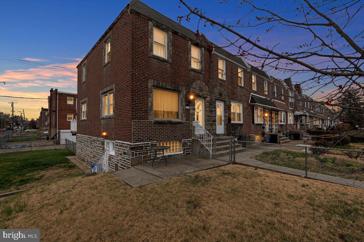 ******* OFFER DEADLINE SATURDAY April 5, 8pm**********Welcome to this well maintained 3 bedroom, 1.5 bath, stone/brick corner property which is situated on a quiet street in the Mayfair section of NE Phila. Approaching you will immediately notice the amazing curb appeal with tasteful landscaping, plush zoysia grass that covers the fenced-in, massive front and side yard, intricate stone work around the door and window frames, and a new steel front door with beveled glass window. Enter to find a spacious & bright living room which features hardwood flooring, an oversized picture window and side windows that allows loads of natural light throughout the entire home. The formal dining area is able to accommodate those large family gathers, includes custom crown moulding, and leads to the kitchen. The kitchen offers plenty of chic white cabinetry, built in appliances, an abundant amount of counter top space, and access to the amazing rear deck which is ideal for relaxing and entertaining. . The second floor boasts 3 generous size bedrooms that include a ceiling light fixtures, closets for plenty of storage, and a updated bright white 3-piece ceramic tile hallway bathroom with updated fixtures, and vanity. The lower level offers endless possibilities and additional finished living space to do as you please, such as family room/office/playroom 4th bedroom, provides a rear and side egress, half bath, massive storage closet that carries into the garage, and a separate laundry area with all the amenities. Additional features include private rear parking and plenty of on-street parking, new hot water heater 2024, amazing rear deck and much more.. Close proximity to top notch schools, all major highways, shopping, and public transportation. Make your appointment today!!