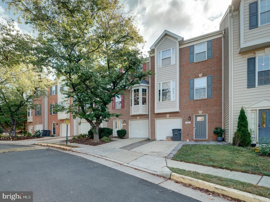 Welcome to 4643 Deerwatch Drive, a beautifully renovated three-level townhome in the sought-after Walney Village community of Chantilly. This home offers three bedrooms, two and a half baths, and a garage. The main level features warm hardwood floors, a bay-window kitchen with granite counters and stainless steel appliances, and a bright bump-out perfect for a home office or reading nook. Custom blinds add a touch of elegance throughout. Upstairs, the spacious primary suite includes a sitting area, walk-in closet, and full bath, while two additional bedrooms and another full bath complete the level. The lower level boasts new luxury vinyl plank flooring, a cozy fireplace, and walk-out access to a private fenced patio. Enjoy peaceful views as the home backs to open common space with lush greenery. Recent updates include new windows and doors, composite deck, Bosch refrigerator, instant hot water heater, and fresh paint. Conveniently located near major commuter routes, shopping, dining, and Dulles Airport.
