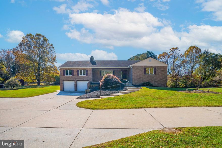 Immerse yourself in the beauty of country living near the Chesapeake Bay, just a short distance from the acclaimed Herrington Harbour South. This expansive raised rancher with a charming brick front is situated on 2.4 acres of mostly cleared land, featuring a spacious tobacco barn awaiting restoration. The property boasts an oversized concrete driveway ideal for your boat or RV, while offering no covenants or restrictions. Relax on the elevated concrete porch as you await the arrival of guests. Inside, the home showcases a bright and sunny living room with hardwood floors, a kitchen with a dining area, a generous family room complete with a wood-burning fireplace for cozy evenings, three well-proportioned bedrooms, and a full bath on the main level. The lower level presents another fully equipped kitchen, a family room with a second wood-burning fireplace, a full bath, and a large bedroom—a perfect setup for in-laws with a separate entrance. Conveniently located just 45 minutes from D.C. and 30 minutes from Annapolis, this property offers an idyllic blend of rural charm and accessibility.