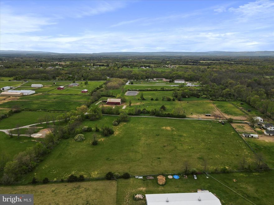 Welcome to your rural haven in Kearneysville, WV, where expansive pastures meet rustic charm on a 17.28-acre plot nestled on Hartack Lane off Middleway Pike. This picturesque property boasts many amenities for equestrian enthusiasts and those seeking a serene countryside retreat.  

At the heart of the property stands a charming barn, complete with stalls, a hay loft, and offering ample space for housing horses and storing equipment. A smaller barn and shed provide additional storage options, ensuring that all your needs are met with ease. The buildings exude rustic charm, adding character and warmth to the landscape.

Spanning both sides of a gravel road, the property offers convenience and accessibility, while maintaining a sense of seclusion and privacy. Partially fenced, the lush, rolling pastureland provides a stunning backdrop for outdoor activities and leisurely strolls.

For those with a passion for horseback riding, a designated riding area beckons, promising endless hours of enjoyment in the saddle. And when it's time to explore beyond the confines of your estate, historic downtown Charles Town and Hollywood Casino at Charles Town Races are just a short drive away.

With its versatile layout and prime location, this property presents a blank canvas for realizing your vision. Whether you dream of expanding the equestrian facilities, cultivating the mostly cleared land, or simply creating a private sanctuary to call home, the possibilities are endless. Bring your ideas and seize the opportunity to unlock the full potential of this Kearneysville gem.