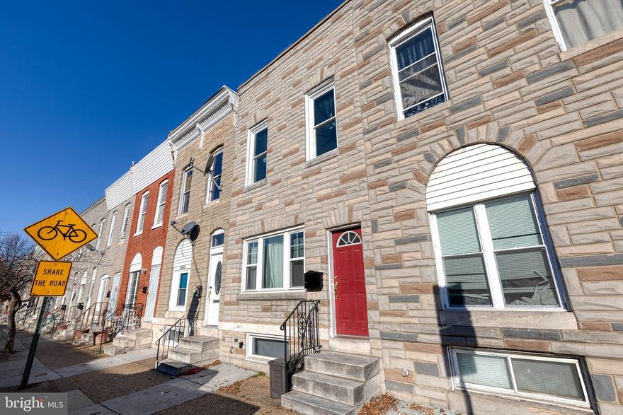 Just blocks from Patterson Park, this charming Highlandtown rowhome offers approximately 1,500 sq. ft. of stylish living space. The open-concept main level features high ceilings, elegant columns, and graceful arches that create a sense of openness and character. A spacious living and dining area includes a convenient wet bar/butler station, perfect for entertaining. The beautifully updated kitchen offers ample cabinet space and modern finishes, while a full main-level bathroom adds extra functionality.
Upstairs, discover three generous bedrooms and a second full bathroom, along with plenty of closet and storage space throughout. The lower level provides additional storage and a laundry area. Enjoy city living at its best with easy access to shops, restaurants, and the vibrant energy of Patterson Park just around the corner. Welcome home!