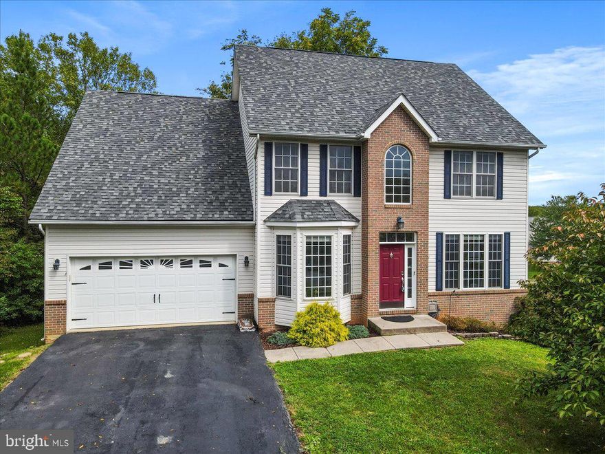 Situated on a corner lot in the golf course community of Locust Hill, this stunning 4 bedroom, 3.5 bathroom Colonial offers an exquisite blend of luxury and comfort. This spacious home features elegant luxury vinyl plank flooring throughout, creating a seamless flow from room to room. The updated kitchen is a chef's dream, complete with a stylish tiled backsplash, stainless steel appliances, a propane cooktop/stove, and a brand new dishwasher. Enjoy meals in the breakfast room or host gatherings in the formal dining room. For those who work from home, enjoy your dedicated office space and utilize the available fiber internet for ultimate productivity. Upstairs, you'll find generously sized, carpeted bedrooms, including a primary suite with a walk-in closet, a soaking tub, and a separate shower. The fully finished basement, completed in 2022, is an entertainer's delight, featuring luxury vinyl plank flooring, a wet bar with a mini fridge, built-in surround sound speakers, and a large full bathroom. Throughout the home, you'll appreciate the fine details such as shadow boxing, wainscoting, and ceiling fans. The laundry room is equipped with a front-loading washer and dryer plus a utility sink for added convenience. Step outside the family room onto the newly painted spacious rear deck, where you can enjoy seasonal golf course views. The new paver patio underneath, complete with an under-deck awning, provides a dry, comfortable space even on rainy days. Updates include a new roof installed in 2018 and dual-zoned heating and cooling with new HVAC units installed in 2019. Surrounded by mature trees and bushes, this home is a perfect blend of luxury and serene living in a great location! (Disclaimer: some photos have been virtually staged.)