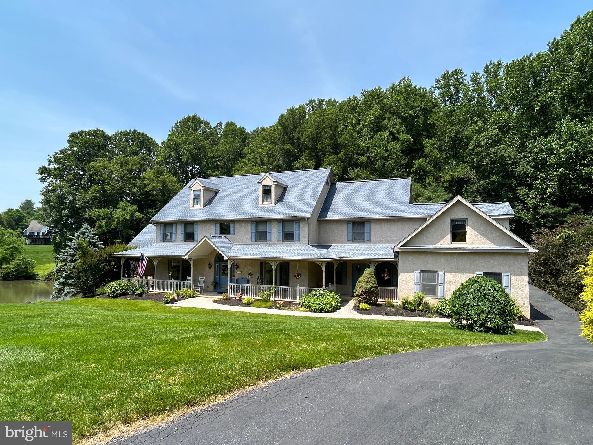 This magnificent home is a one-of a kind and offers so much versatility!
As you approach, you’ll notice the picturesque lot with plenty of privacy. The rear yard backs up to wooded area and features a large pond that sits entirely on this property, just under one-acre in size. Pond is stocked with various award-winning Koi and is a haven for wildlife!
Entering the home, you are greeted by a dramatic two-story foyer with cathedral ceiling and grand staircase. The adjacent living room features crown molding and a deep-silled bay window, perfect for a quiet room and living space. The formal dining room features all the finishing touches, including shadow-boxed wainscoting and deep-silled windows.
The spacious kitchen features glistening quartz countertops that extend to the large center island. An elegant gas fireplace with stone hearth and quartz mantle adorns the kitchen, adding just the right touch. The kitchen is well-equipped with a double-wall oven, premium cabinetry, and custom built-ins. The tile flooring extends into the large eat-in area that overlooks the step-down family room with a soaring two-story cathedral ceiling and a stone hearth located on a wall of windows, bathing the area in natural light.
Doors lead to the three-season room that overlooks the private wooded rear yard, and lead to the entertaining-size rear deck—take the party outside—not that you need to with over 7,000 square feet of living space!
Back inside, you’ll find the spacious first-floor master suite with large walk-in closet and with sliders leading to a deck off the suite, overlooking the tranquil wooded setting. A gorgeous pass-through gas fireplace is shared with the tile master bathroom with jacuzzi tub with designer window that overlooks the serene pond.
Upstairs, you will find a large princess suite with double closet and tile bathroom with skylight. Two generously-sized bedrooms complement the tile hall bath with double vanity and tub/shower. An expansive bonus room completes the second floor, complete with its own outside entrance. This is perfect for a home office or large hobby room!
The lower level of this home includes a fully finished basement that is a home unto it self, with a full kitchen, two bedrooms and living room that features a stone accent wall and gas fireplace. Sliders lead to a ground-level covered hardscaped patio.
In addition to the finished basement, an attached unit—perfect as an in-law suite or au pair suite—features a full eat-in tile kitchen, two bedrooms, a full bathroom, and a living room that walks out to the covered hardscaped patio. This unit is metered separtately for utilities and has its own HVAC zone.
There is plenty of storage inside this home, perfectly complementing the spacious three-car attached garage.
This home features a 50-year roof, newer heating units and efficiently-zoned HVAC units, to provide years of trouble-free service! A fully-transferrable home warranty has 18 months remaining for the new owner to take advantage of!
The location is ideal—off the beaten path in an established neighborhood, yet convenient to major travel routes and all that West Chester Borough has to offer in shopping, dining, and entertainment! Take advantage of the award-winning West Chester School District! This is a one-of-a-kind, must-see home!