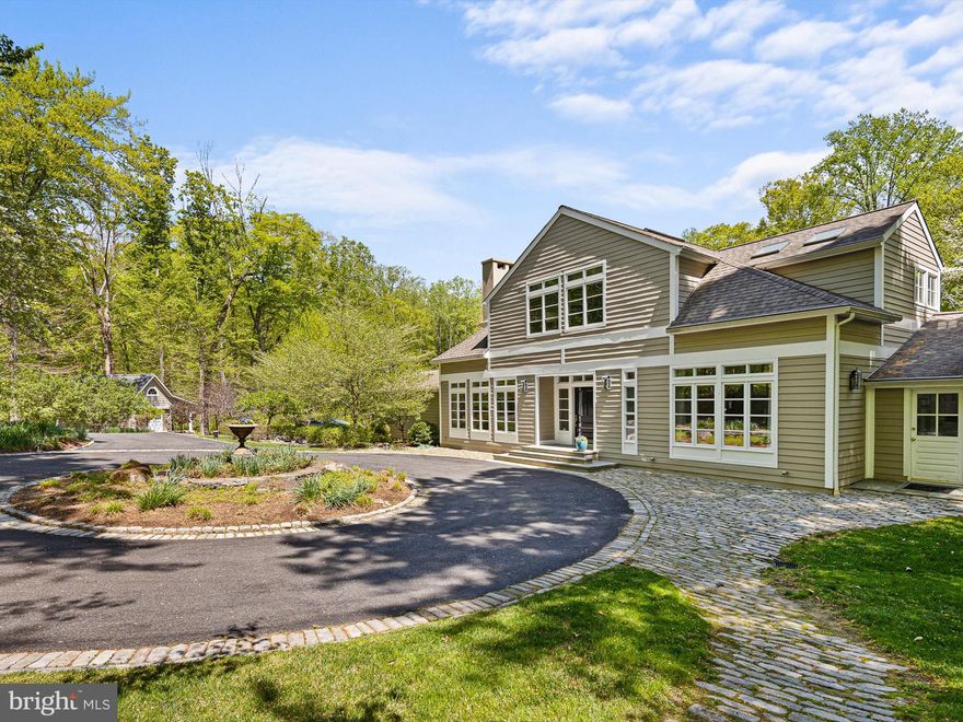 Architect-Designed Estate in Fair Hill | Unionville-Chadds Ford School District
Welcome to this exquisite custom home in the highly desirable Fair Hill neighborhood, located within the top-ranked Unionville-Chadds Ford School District. Privately nestled on 2.6 acres and surrounded by nearly 100 acres of protected conservancy land, this estate offers unmatched privacy and natural beauty along the scenic Rt. 52 Corridor.
Designed by renowned architect Otto Sperr, the home boasts an expansive and light-filled open floor plan, perfectly balancing classic elegance with modern comfort. The welcoming entryway opens to panoramic views through the sunroom, overlooking a flagstone patio, firepit, and a picturesque stream that skirts the property—an idyllic setting with plenty of space for a future pool or sport court!
Inside, you'll find 4 bedrooms, including a first-floor primary suite that has built-ins, a large walk-in closet, as well as a bank of windows that overlook the private wooded yard. The large en-suite bath has radiant heated floors, large dbl vanity, built in shelving and oversized walk in shower. Upstairs find  2 additional well sized bedrooms, 1 with en-suite bath and the second with a shared bath that is convenient for the unique 3rd room office or flex space-think nursery/playroom. The heart of the home is the beautifully updated chef’s kitchen, complete with custom cabinetry, Sub-Zero and Thermador appliances, and a center cooktop island perfect for entertaining. 
Additional highlights include a formal dining room, a living room with fireplace, and a comfortable den with raised gas fireplace and  library shelving. The finished lower level offers even more space with a family room, 2 additional bedrooms/offices, and a full bath—ideal for guests or multigenerational living.
A separate heated carriage house/garden shed with a charming porch adds incredible versatility, whether for a studio, guest space, or workshop. The property is also equipped with a whole-house generator for added peace of mind.
This is a rare opportunity to own a stunning architectural gem in a premier location—where timeless design meets exceptional privacy and natural beauty.