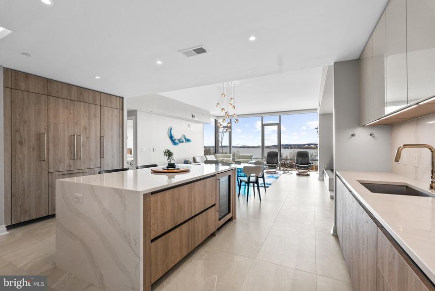 Immerse yourself in upscale comfort at the MUSE, a premier waterfront condominium in Old Town Alexandria’s thriving Arts District. Light-filled and refined, this waterfront two-bedroom, two-bath over 1600 sq. ft. residence is framed by soaring 10+ foot ceilings and dramatic floor-to-ceiling windows in the main living areas and bedrooms, creating an airy, light-infused atmosphere throughout. Porcelain tile floors imported from Italy extend seamlessly throughout the home, offering both modern elegance and exceptional durability.  A generous balcony is accessed from the living room, both with river views.

Designed for the discerning chef, the open-concept kitchen showcases sophisticated Italian Snaidero cabinetry—the top cabinets have been upgraded to a sleek high-gloss finish for a striking contemporary look—alongside premium Bosch appliances and upgraded quartz countertops and quartz backsplash. An oversized island with deep storage drawers including internal drawers, counter seating, and a built-in wine cooler anchors the beautiful open layout.

Unwind in the private primary suite, highlighted by great views, two custom walk-in closets, and a spa-inspired bath featuring a dual-sink vanity, LED backlit mirrors, and tile extended to walls. The spacious second bedroom with walk-in closet is situated on the opposite side of the home, increasing privacy in both bedrooms. Additional full bath, laundry room, and custom built desk nook with Snaidero cabinetry complete the home.

Included with this residence are two rare perks for condominium living: a large storage unit and two assigned garage parking spaces in a prime location, delivering a true lock-and-leave lifestyle.

Meanwhile, MUSE pampers residents with exceptional amenities. A 24-hour concierge, on-site manager, and building engineer ensure effortless living, while the penthouse clubroom—complete with a full kitchen, outdoor grills, and generous indoor and outdoor seating—offers breathtaking panoramas of DC’s monuments, the Potomac River, and Old Town’s skyline. A penthouse-level fitness center and yoga studio, with an outdoor training terrace and state-of-the-art equipment, make it easy to stay active year-round.

Positioned just steps from the Mount Vernon Trail and moments from vibrant Old Town’s shops, restaurants, Saturday Farmer’s Market, Metro access, Ronald Reagan Washington National Airport, Amazon HQ2, National Harbor, and Washington, DC, MUSE flawlessly merges convenience, modern design, and upscale amenities.

If you’ve been dreaming of a refined waterfront sanctuary in Old Town, don’t let this rare opportunity pass you by.

Updates done by the seller include: new porcelain tile floors imported from Italy in living room, dining area, kitchen and bedrooms; upgraded the Snaidero cabinets over the kitchen countertops to a high-gloss finish; extended wall tile over the sinks in the primary bathroom to cover all walls; extended the wall tile from bathroom door, over the sink and all the way around the bathtub in secondary bathroom; installed additional/new light above vanity mirror; installed new handheld shower in the secondary bathroom; installed two new large Snaidero cabinets and a small built-in desk with a quartz desktop in laundry room; custom closet organization systems in bedroom closets and entry closet; installed new electrical outlets in all the closets; installed new wide wood sills at base of all the windows; installed new quartz floor dividers at the entrance to closets, laundry room and bathrooms; installed two new Snaidero internal drawers inside the kitchen island drawers; upgraded smaller storage unit to larger storage unit; installed new quartz countertop and backsplash in kitchen.