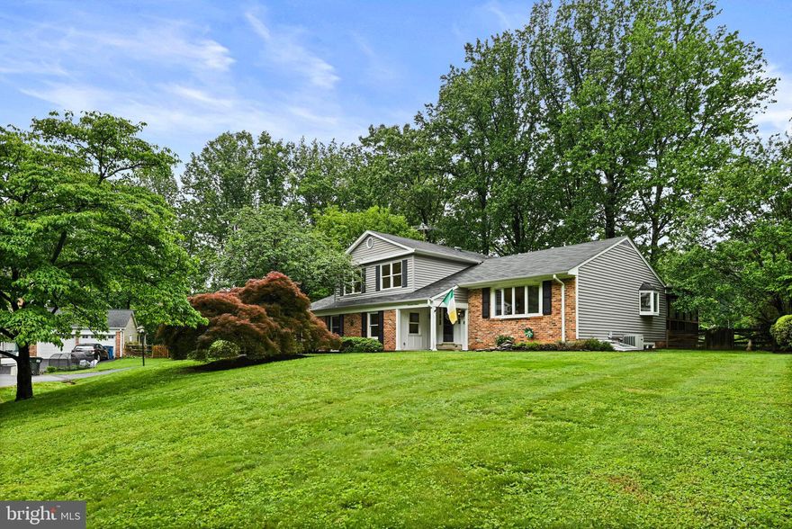 Welcome to 1716 Saddle Ridge Court!  Don't miss out on this opportunity to own a  beautifully updated 3200 finished square foot home nestled on a quiet cul de sac in Vienna. A spectacular four level, split level home on a .52 acre lot that backs to lush trees deep inside the sought after neighborhood of Wayside. This property is a nature lover's delight! Top notch school pyramid of Oakton ES/Thoreau MS/Madison HS! No HOA but active voluntary civic association. The open Foyer warmly pulls you in and welcomes you to stay awhile. Just a few steps up takes you to the Living Room which boasts a large bay window and warm wood floors. The Dining Room with a built-in wine rack and bar storage also has a large bay window, but more impressively the French doors open wide on to the large screened-in porch that overlooks the back garden and patio. The large, open Kitchen has granite countertops, high end appliances, a 6-burner gas cooktop by Dacor with a high volume Best exhaust system, and a custom artwork mural backsplash. Enjoy meals in the separate dining area or the breakfast bar. Half a level down from the gourmet kitchen is a spacious Family Room with a stunning fireplace and access to the patio and hot tub area. Also, on this level is a Full Bath, 5th Bedroom, Laundry Room and off the Family Room is access to the spacious 2 car garage. Three spacious bedrooms await you on the Upper level with two full Bathrooms.  The Primary Bedroom has access to a private deck for your morning coffee or tea and a custom extra-large walk-in closet with a full-size window and an updated ensuite large full Bathroom. The second full Bath is conveniently located on the upper-level hallway with a bathtub. Both bedroom 2 and bedroom 3 are located at the front of the home. In the finished basement, you will discover the fourth bedroom with a Murphy Bed and adjacent full bathroom. Also in the lower level is a large Recreation Room and Wet Bar as well as a Storage Room. 
 
This home offers easy access to the W&OD Trail, walking trails and beautiful parkland. The Hunter Mill Swim and Racquet Club is a ½ mile walk within the neighborhood (membership required). Commuting is effortless with proximity to the Metro, Dulles Airport, and major routes. Plus, you’re just a short drive to Tysons Corner, Reston Town Center and downtown Vienna, where world-class shopping, dining, and entertainment await.