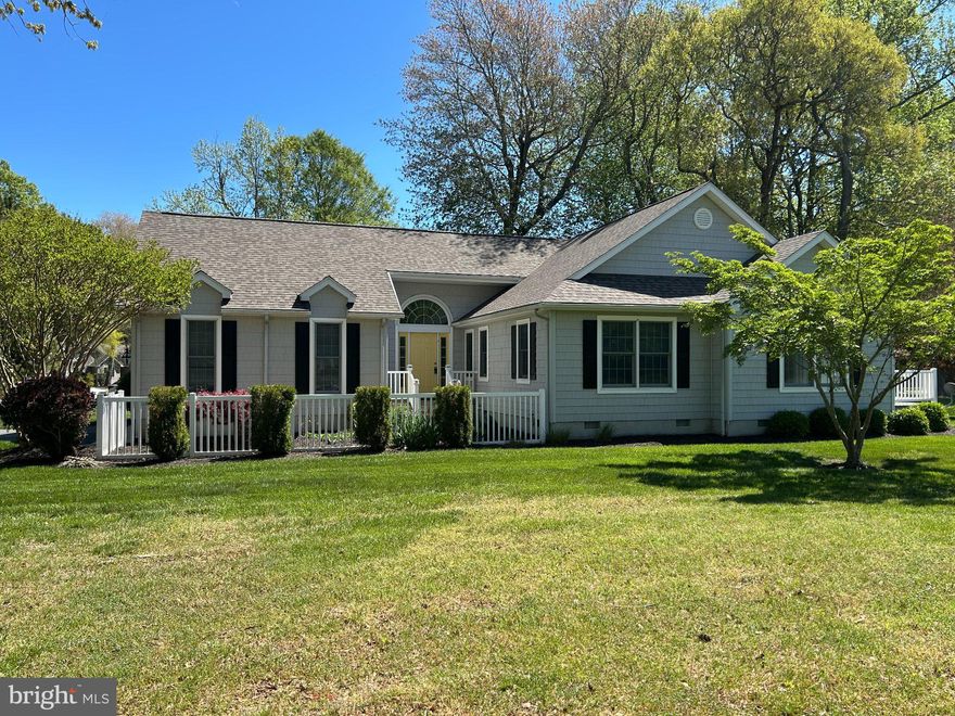 Enter this contemporary, 3 bedroom, 2 bath cottage home featuring a charming fenced in garden courtyard to the front door.  Entry foyer leads to an open floor plan with beautiful hardwood floors throughout.  Kitchen off of great room features granite counters, island, two pantries and a lovely window seat with storage.  This light filled home has a spacious sunroom with wet bar that will be the center of your entertaining;  this opens to a rear deck with a retractable awning for outside relaxing. Grill on deck is conveniently connected to a gas line . Bonus for buyers is a new roof and heating system, sprinkler system in yard, gutter guards, outdoor shower and 2 car garage with area for a workshop. Located on a corner lot and only a short walk to community center, pools (indoor and out), tennis, volleyball and pickle ball courts, shuffleboard, and public 18 hole executive golf course.  Water access to the 90 acre Salt Pond is ideal for kayaks, canoes and water fun. Short drive to Bethany's boardwalk, shops and restaurants. Come home to a quiet neighborhood and enjoy all that the Salt Pond community has to offer.