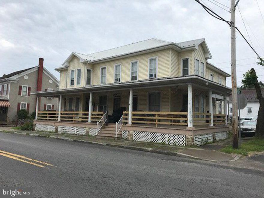 3 unit apartment house.  Needs TLC but brings in $1100 per month.  Baseboard electric with separate meters.  2 big outbuildings plus a small one.