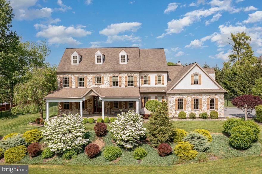 Discover your dream home nestled on 1.42 acres of private land in a serene neighborhood characterized by rolling country hills. This exquisite 5-bedroom stoned house is designed for both luxury and entertaining.  Enjoy the elegance of gorgeous hardwood floors paired with brick tile throughout this expansive home. The open floor plan features 10-foot ceilings and large molding, creating an airy and welcoming atmosphere perfect for entertaining guests. Tailored for culinary enthusiasts, the kitchen boasts custom drawers, an oversized sub zero refrigerator, convenient pot filler and an industrial oven. Immerse yourself in the pleasure of cooking in a space designed for a chef. Retreat to the comfort of the stunning oversized primary suite, ideal for unwinding with a cozy blanket and a good book. The home is adorned with interior designed drapery and brilliant lighting fixtures, adding to its bespoke charm. The finished lower level includes a living area, bathroom and a roughed-in bar, perfect for hosting events and personal enjoyment. Step outside to a spectacular backyard oasis featuring a custom gunite pool and jacuzzi, set on a beautifully stoned patio. The pool house comes complete with a built-in kitchen and a lovely fireplace, offering a perfect spot for relaxation or social gatherings. Savor peaceful mornings and evenings on the cozy wrap-around front porch, where you can enjoy stunning views of the surrounding tranquility and fresh air. Take leisurely walks to the nearby farmer for fresh eggs or enjoy the local scenery, ensuring a lifestyle of peace and simplicity. The property includes a roomy 3-car garage, catering to all your storage needs. Situated just 9 miles from Hershey Medical Center and minutes to shopping, the home offers easy access to local amenities and services. Whether you're looking to entertain or escape in your own private haven, this home offers it all.