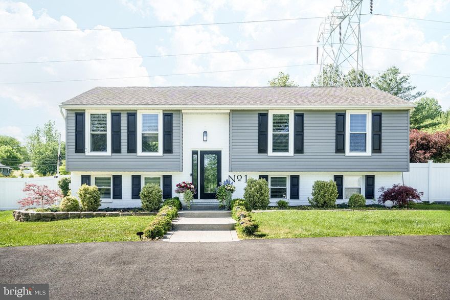 Beautifully renovated home on a spacious fenced lot in Conowingo featuring designer upgrades, flexible living spaces, and an impressive open-concept layout. The stunning gourmet kitchen offers an oversized waterfall-edge island with hidden storage cabinetry, farmhouse sink, gas cooktop with pot filler, custom cabinetry, beverage station with wine refrigerator, and extensive seating and prep space. The bright main living areas feature updated flooring, recessed lighting, and seamless flow for everyday living and entertaining. The finished lower level provides additional living space with a custom fireplace feature wall, built-in shelving, a full bathroom, bedroom options, and walkout access to the backyard. Multiple bedrooms offer flexible layouts, including spaces with built-in desk areas and mini-split systems.

The spa-inspired bathrooms showcase custom tilework, oversized glass showers, double vanity areas, and modern finishes throughout.

Outdoor features include a large fenced backyard, elevated deck, detached outbuilding, landscaped grounds, decorative garden arbor, and plenty of room for entertaining, recreation, or gardening. Conveniently located with easy access to local commuter routes while offering a peaceful setting with modern updates throughout.